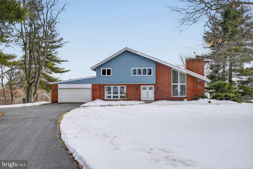 Welcome to this uniquely designed 4-bedroom, 2.5-bath home located in the heart of highly sought‑after Souderton, within the acclaimed Souderton Area School District.  Nestled on a serene 1.35-acre lot in a quiet community, this home blends architectural character with modern updates and an abundance of natural light.  As you enter through the foyer, you are immediately greeted by the home’s distinctive architectural style. The foyer flows seamlessly into the updated kitchen, featuring new cabinets, a stylish backsplash, and elegant quartz countertops. The kitchen opens to the dining room, where original hardwood floors add warmth and charm.  Conveniently located on this level is a laundry room with garage access, as well as a half bath for guests. A versatile flex room completes this floor—ideal as a main‑level bedroom, home office, playroom, or additional entertainment space, also accented with original hardwood flooring.  Just a few steps up, you'll find the stunning vaulted‑ceiling family room, showcasing oversized windows and sliding glass doors that flood the space with natural light. A beautiful gas fireplace serves as the focal point, creating the perfect ambiance for both relaxing and entertaining.  The second staircase leads to the upper level, where you’ll find four bedrooms, each featuring beautiful hardwood floors. A full hall bath serves the secondary bedrooms, while the primary bedroom offers its own ensuite bath for added comfort and privacy.  Step outside to appreciate the expansive 1.35-acre property, offering a sense of privacy and plenty of room to enjoy nature. Walk out to the large backyard and enjoy outdoor living on the updated composite deck and paver patio area, perfect for relaxing, entertaining, or taking in the peaceful surroundings.  Some recent updates include an updated kitchen, waterproofed basement, new furnace, new hot water heater, a Gutter Helmet system, and a newer Trex deck and paver patio—providing long-term value and peace of mind for the next homeowner.  All of this is located just minutes from local parks, shops, and restaurants in the vibrant Souderton community.  A wonderful blend of character, space, and thoughtful updates—this Souderton gem is one you won’t want to miss.