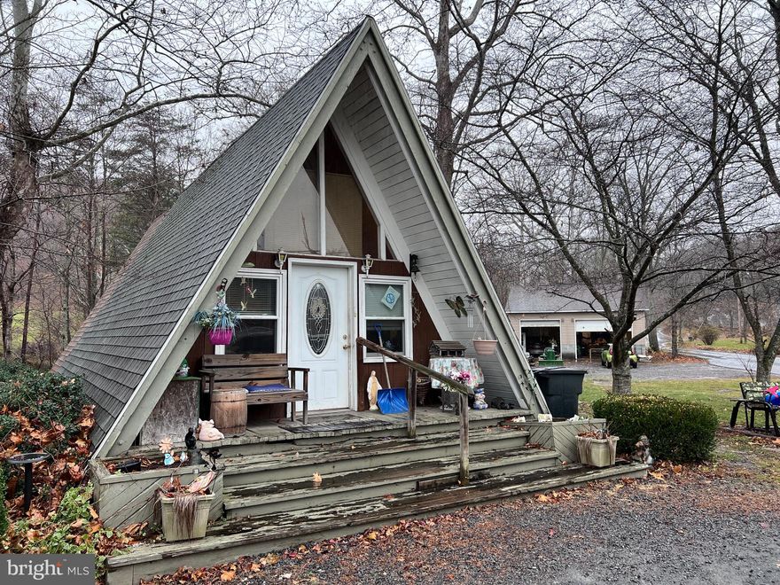 Own Your Own Tiny Home!   Featuring:  1 Bedroom, 1 Bath, Kitchen, Living Room, closet with washer & dryer hookup and Loft.   PLUS a detached 2 car garage and storage shed.   Situated on .90 acre with a wet weather stream.  Lots of possibilities!  Business, weekender, or full time residence.   Just minutes from Cacapon State Park where you can enjoy hiking, golf, horse back riding, playground, lake for swimming/fishing, lodge/restaurant PLUS so much more!