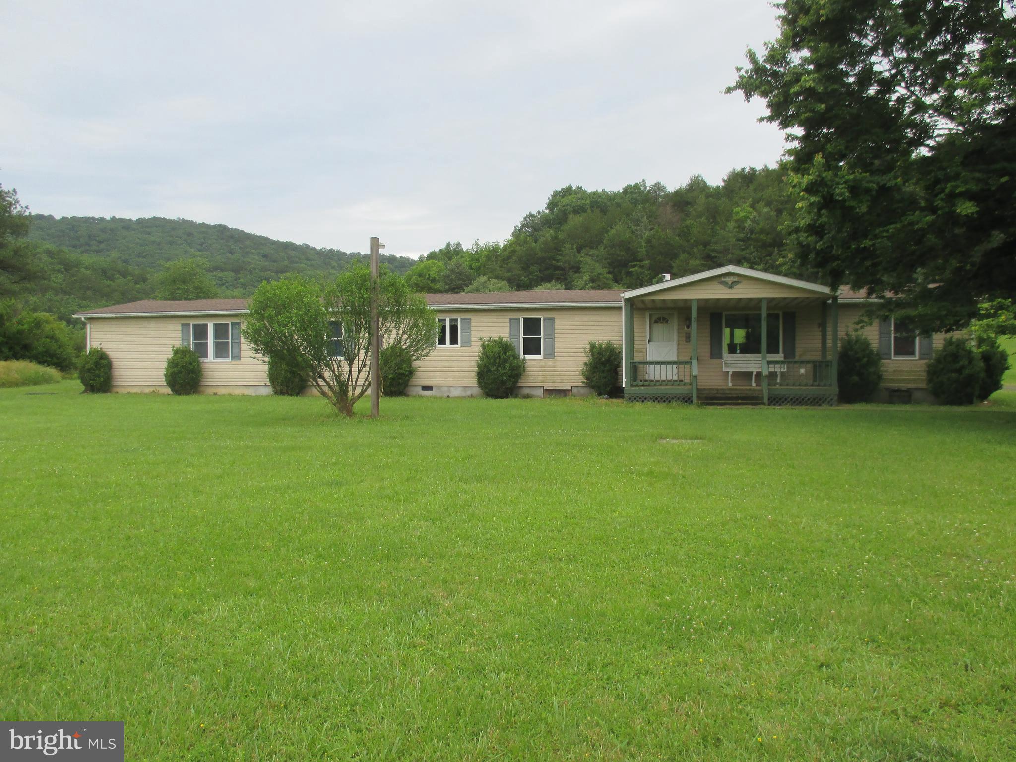 UNBELIEVABLE PANORAMIC MOUNTAIN VIEWS AND A PRIVATE SECLUDED PRISTINE SETTING IS WHAT YOU'LL FIND WHEN YOU TOUR THIS HOME ON OVER 13 ACRES. LARGE FRONT AND REAR LEVEL YARD WITH A COMBINATION OF OPEN FIELDS, PASTURE, AND WOODLAND. LARGE RANCH STYLE HOME FEATURING 4 BEDROOMS AND 2 1/2 BATHS. THE DETACHED 2 CAR GARAGE HAS A WORKROOM AND AN OFFICE AREA. COVERED FRONT PORCH AND A LARGE COVERED REAR PATIO FOR OUTDOOR COOKING AND ENTERTAINMENT OVERLOOKING THE BEAUTIFUL OPEN FIELDS. BUT THAT'S NOT ALL, DRIVE A SHORT DISTANCE UP THE HILL AND YOU WILL FIND A 1 ROOM CABIN OVERLOOKING THE DISTANT MOUNTAINS AND VALLEY BELOW. ALL OF THIS FOR YOU TO ENJOY AT YOUR SECLUDED COUNTRY ESTATE.