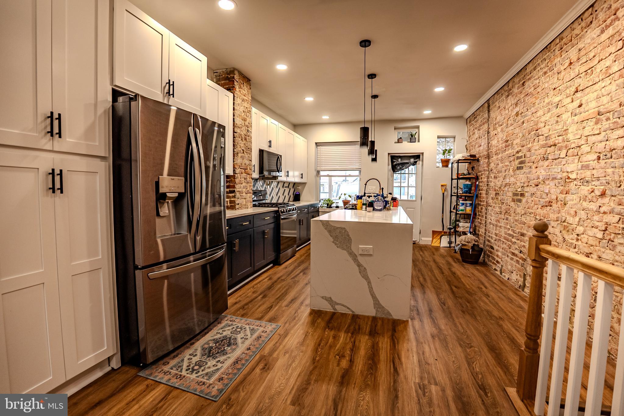 Experience the charm of this beautifully renovated 4-bedroom, 3-bath home in the highly desirable Brewers Hill neighborhood. Step inside to a bright, open-concept living area enhanced by tray ceilings and premium flooring throughout.
The chef-inspired kitchen features sleek black stainless steel appliances, elegant quartz countertops, an oversized island, and ample cabinetry—perfect for both everyday living and entertaining.
Upstairs, you’ll find 2 spacious, thoughtfully designed bedrooms and a 2 spa-like bathrooms, along with access to a stunning two-level rooftop deck offering incredible views. The fully finished lower level offers brand-new carpeting, two versatile bedrooms—one featuring original French doors from the home’s first kitchen—and a full bathroom, providing endless options for guests, a home office, or a personal gym.
Enjoy the convenience of a private parking pad and unbeatable location just steps from breweries, fitness studios, parks, shops, and dining. Commuting is easy with quick access to I-95. With pet-friendly accommodations, this home perfectly combines upscale living and city convenience.