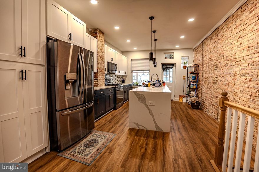 Experience the charm of this beautifully renovated 4-bedroom, 3-bath home in the highly desirable Brewers Hill neighborhood. Step inside to a bright, open-concept living area enhanced by tray ceilings and premium flooring throughout.

The chef-inspired kitchen features sleek black stainless steel appliances, elegant quartz countertops, an oversized island, and ample cabinetry—perfect for both everyday living and entertaining.

Upstairs, you’ll find 2 spacious, thoughtfully designed bedrooms and a 2 spa-like bathrooms, along with access to a stunning two-level rooftop deck offering incredible views. The fully finished lower level offers brand-new carpeting, two versatile bedrooms—one featuring original French doors from the home’s first kitchen—and a full bathroom, providing endless options for guests, a home office, or a personal gym.

Enjoy the convenience of a private parking pad and unbeatable location just steps from breweries, fitness studios, parks, shops, and dining. Commuting is easy with quick access to I-95. With pet-friendly accommodations, this home perfectly combines upscale living and city convenience.