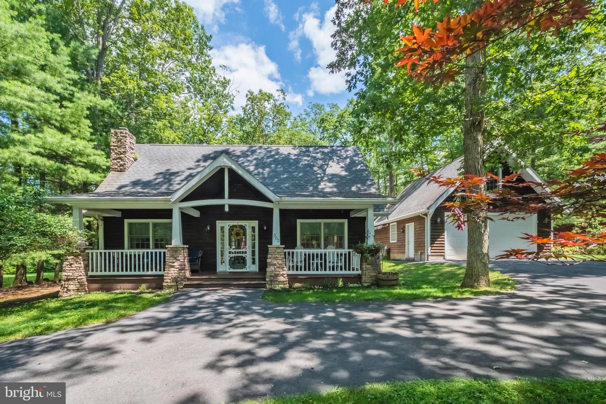 4BR, 4BA lake access cottage with assigned boat slip nearby! Incredibly cozy feel and impressive gas fireplace. Classic front porch area and a circular, paved driveway and over-sized detached garage with additional living space. Amazing backyard is perfect for entertaining year-round -- spacious deck, fire pit and hot tub. Home is being sold furnished! NO HOA - dock association only. The Harbor Association community dock has deep water access and is in a no wake zone, just a few hundred yards away.