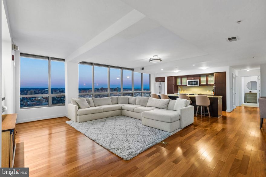 Rising high above Harbor East, this extraordinary three bedroom, three bath condominium at The Vue redefines luxury living with its breathtaking open-sky views and natural light streaming through floor-to-ceiling windows on the 27th floor. Spanning over 1,900 square feet, this residence features a Chef’s kitchen with an expansive center island, complemented by upscale finishes such as rich hardwood flooring, designer light fixtures, custom closets, and upgraded blinds. The open-concept living and dining areas create an inviting space ideal for both entertaining and relaxation. The impressive corner master suite boasts floor-to-ceiling windows with double exposures, a spacious walk-in closet, and a spa-inspired bathroom with a double vanity, separate shower, and deep soaking tub. Included with this offering are two premium parking spaces. The Vue is a full-service condominium located in the heart of Harbor East, just steps from premier restaurants, boutique shopping, Whole Foods, Starbucks, and the vibrant Inner Harbor waterfront. The condo fee covers AC, heat, water, security, and concierge services. Residents also enjoy the convenience of direct elevator access to the MAC gym and Harbor East movie theater.