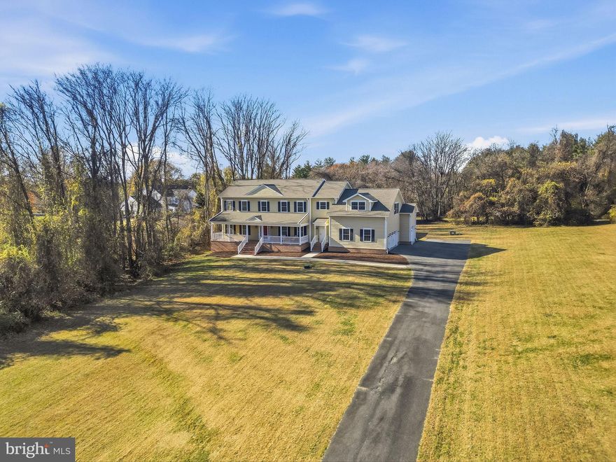 Welcome to 14239 Seneca Road in Darnestown, a 1.09-acre sanctuary that brings together refined living, quiet natural charm, and effortless comfort. It's the kind of property that immediately feels welcoming, spacious, tranquil, and beautifully in tune with the landscape around it. Part of the Spring Meadows subdivision and free from HOA restrictions, this one-of-a-kind custom home offers a rare sense of privacy and the freedom to shape the lifestyle you want. A sweeping forty-six-foot covered brick front porch creates a warm, gracious welcome and hints at the thoughtful design carried throughout the home, built with care by the original owners. Inside, natural light fills each room, lifted by 9-foot ceilings and a floor plan designed for both easy gathering and comfortable retreat. The updated gourmet kitchen is a true centerpiece, featuring custom cabinetry, new quartz countertops, premium appliances, and an inviting breakfast area that opens through French doors to peaceful backyard views. The breakfast area and the formal dining room make the main level ideal for everything from casual mornings to elegant dinner parties. Nearby, the light-filled great room, anchored by a cozy natural gas fireplace, opens to a secluded 17' x 17' screened-in porch, the perfect spot to enjoy quiet mornings and relaxing evenings as you take in your peaceful surroundings. The private backyard attracts a variety of wildlife year-round giving you a front row seat to nature. The main level also features a spacious first-floor primary suite with generous walk-in closets and a spa-like bath. Completing this level are a mudroom, pantry, powder room, laundry room, the convenience of both front and rear staircases, and an over-sized 3-car garage, thoughtfully placed to make daily living feel seamless. Upstairs, four large bedrooms, each with its own private ensuite bath, offer comfort and privacy for family and guests. The upper-level family room is an unexpected showpiece: a vast, sunlit gathering space with skylights, a natural gas fireplace, and a full wet bar with sink, dishwasher, and beverage cooler. Together with a second laundry room steps away, this level functions almost like a self-contained wing, perfect for family game nights, movie marathons, or a private oasis for overnight guests. The expansive lower level adds more than 2,600 square feet of possibility, offering an open layout with high ceilings, a finished full bath, and a walk-up exterior entrance. Whether you envision a home gym, theater, guest suite, or creative studio, the space is ready to evolve with your needs while still providing abundant storage. Throughout the home, every detail reflects quality craftsmanship and long-term care—from the hardwood floors and ceramic-tiled baths to the HardiPlank siding, fire sprinkler system, central vacuum, and whole-house water filtration. A Generac natural gas generator, a newly installed tankless hot water heater, updated HVAC systems, and recently replaced appliances further enhance comfort and efficiency. Ideally located between Germantown, Gaithersburg, and Potomac, the property offers quick

access to shopping, dining, parks, and major commuter routes, including River Road, I-270, Route 28, and Great Seneca Highway. The surrounding area is known for strong long-term property appreciation, making this home not only a peaceful retreat but also a smart investment. Beautifully maintained, thoughtfully updated, and perfectly situated, this is a rare opportunity to enjoy privacy, space, and luxury in one exceptional setting. This is more than a home, it's a lifestyle.