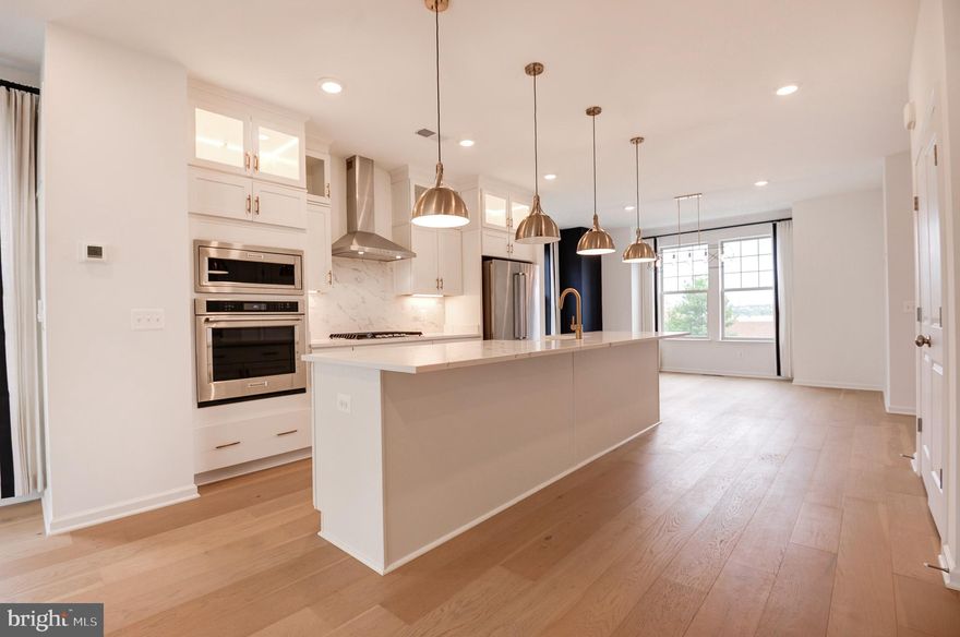 Previously a BUILDER MODEL HOME at Potomac Station Marketplace Sub-Div! Never lived in home!! Staged pictures are the BUILDER MODEL HOME pictures to give an idea of the furniture placement <br> <br> END CORNER TOWN HOME, interior finished 2,298 sq ft @ 4 levels, 2 car rear garage w/opener. Guest parking spaces available  at the sub-division streets. Steps away to sub-div's tot lot <br> <br> Home situated right across the Marketplace at Potomac Station. A great centralized location within short distance to Primrose, Downtown Leesburg, Leesburg Premium Outlets, Village at Leesburg, CMX Village 14 Cinemas, Costco, Target, Walmart, Home Depot, Walgreens, Best Buy, Wegmans, Traders Joe, W&OD biking trail, & more. Proximity to several major commuting routes; Leesburg Bypass, HWY-15, I-267, Battlefield Pkwy, & Rte 7 <br> <br> Dream Finders built, Addison floorplan; an appealing modern & versatile design where comfort & convenience merge seamlessly. The MAIN level is the heart of the home, w/an open-concept great room, dining area, & well appointed stunning kitchen; gourmet kitchen w/quartz counters, backsplash, two-tier cabinets, glass cabinets, pendant lights, under cabinet lights, huge undermount farm house sink, & humongous centre island. A powder rm & an access to a nice size deck that enhances outdoor living completes the main level. At UPPER level are the 3 spacious bed rms; the primary bed rm w/an en-suite bath rm & a large walk-in closet. The two scondary bed rms down the hall share a full bath rm. Washer & Dryer w/cabinets. The UPPER TWO level has a coxy loft w/terrace. The LOWER level features a spacious recreation room; perfect for a game room or home office, along with a two-car garage <br> <br> Amenities include a community gathering area, seating area, gazebo, & tot lot | Access to parks, playgrounds, walking trails & much more | Excellence in style, function & location.