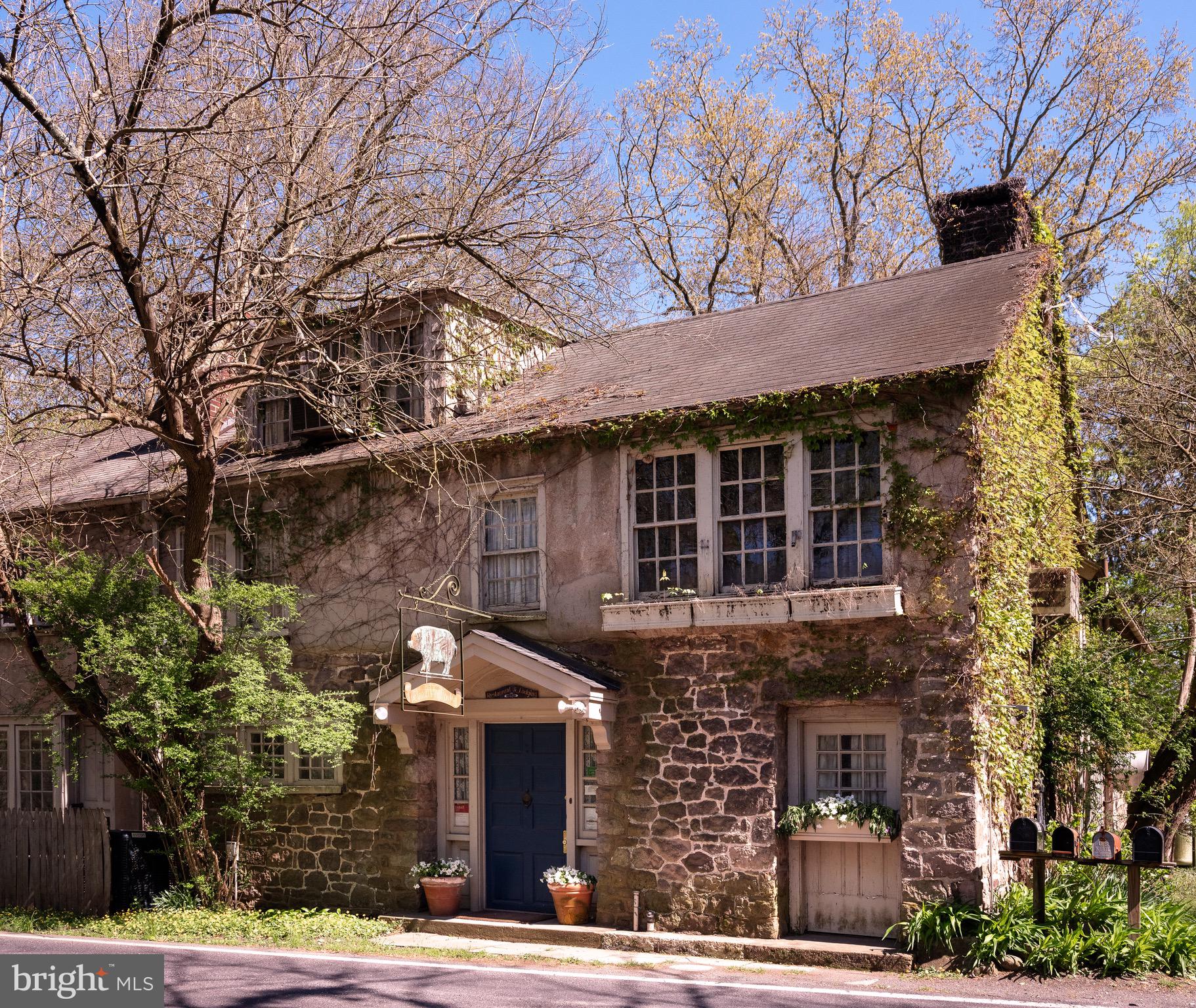 An extraordinary opportunity is now available to acquire one of Bucks County’s most storied properties. The Inn at Phillips Mill, located in the nationally recognized Phillips Mill Historic District, has a rich history as a cherished fine dining destination and is now offered as a historic property with incredible redevelopment potential. Originally built in the 1750s and later transformed for use as a restaurant in the early 1970s, this captivating stone building has long been a landmark of rustic elegance and timeless character.
Nestled just minutes from downtown New Hope and overlooking scenic river vistas, the Inn is surrounded by a vibrant arts community steeped in cultural heritage. The building boasts original stone walls, antique wood finishes, and glowing fireplaces, with a garden patio that once provided an intimate setting for al fresco dining during the warmer months. The architectural integrity, historic designation, and enduring charm of the property remain, offering a blank canvas for restaurateurs, hospitality entrepreneurs, or investors seeking to reimagine this iconic space.
This unique property presents the opportunity to own a piece of New Hope’s heritage while positioning your vision in one of Pennsylvania’s most desirable markets. With its prominent location along River Road, the Inn at Phillips Mill continues to captivate the interest of both loyal patrons and heritage enthusiasts. Whether you choose to revive the dining legacy or transform the building into a boutique hotel, event venue, or an entirely new concept, this is a once-in-a-lifetime chance to create something remarkable in a setting steeped in history.