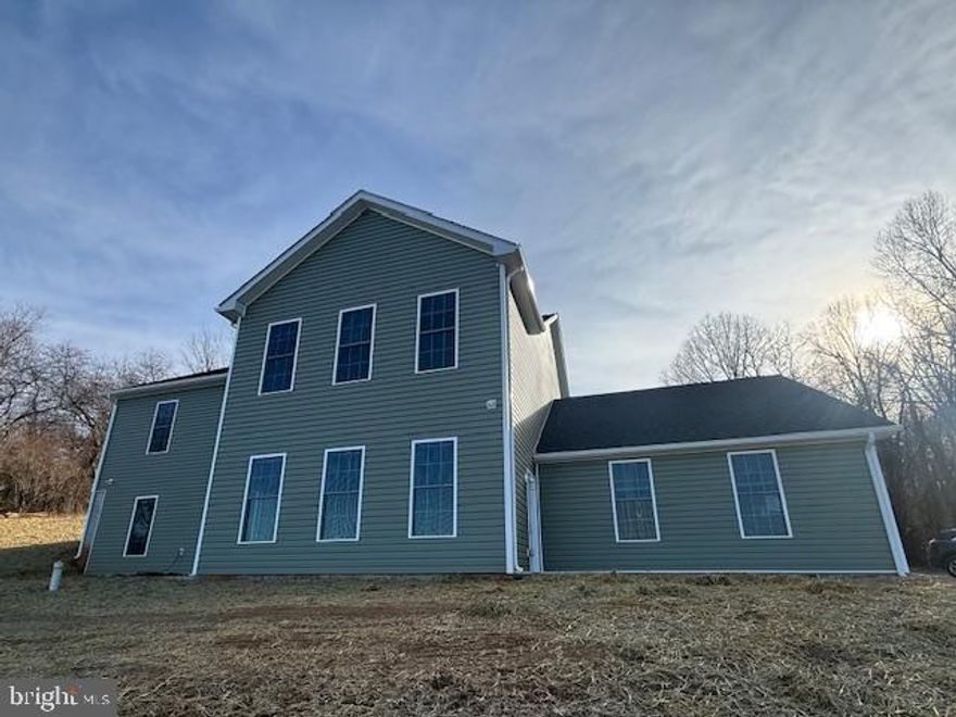 A little slice of heaven with breathtaking views that go for miles! Close to everything but offering privacy and tranquility. A very rare opportunity to live in this brand-new beautiful home that is now ready for its new occupants! As you walk up to the front of the home you will see an amazing panoramic view of nature at its finest and off in the distance the lovely Blue Ridge Mountains. As you enter the entry level from the garage or the exterior door, you will find a HUGE recreation/family/great room with a wall of windows and a glass door that leads to a patio area and the most amazing view! On this entry level you will also find two large bedrooms, a full bath and a laundry room, making for a perfect space for anyone that likes a step free living space. The gleaming luxury plank floors are so inviting and offer so much class to this lovely home on both levels. The main living area is up a flight of stairs from the garage level - however it is ground level in the front of the home with easy access to everything you might want for one level living including the kitchen, family room, dining room, breakfast room and three bedrooms and two full baths on this level. A very large deck sprawls across the entire face of the home on this level, offering wonderful space to enjoy the lovely nature from your front porch. This deck is perfect for entertaining, relaxing and enjoying the sunset or sunrise.  Here you will find an oversized family room with plenty of natural light filtering in from the ample windows on multiple sides of the home.  A large dining area is adjacent to the family room and leads directly to a fabulous kitchen with an eat in dining area. The kitchen is very nicely appointed with a brand-new everything, including gorgeous cabinets, countertops, stove and microwave and refrigerator and dishwasher. Down the hallway you will find bedroom number two and bedroom number three, both with easy to clean LVP flooring, ceiling fans and large closet spaces. There is also a hall bathroom on this level with a full bathtub and shower. The primary bedroom suite also with LVP flooring, a ceiling fan, large closet and private bathroom. All the bedrooms have plenty of natural light from the wonderful window lines found in each room. The side loading two car garage has extra storage and garage door openers. Located on over three acres, you will find plenty of space to roam and play.