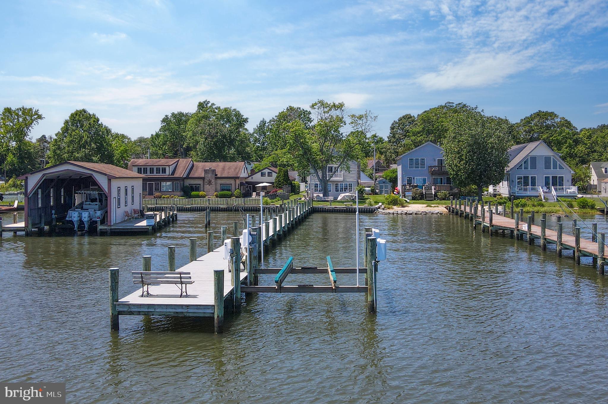 Nestled along the tranquil shores of Selby Bay, 3685 1st Avenue in Edgewater, Maryland, offers an unparalleled waterfront lifestyle. This charming 4-bedroom, 2.5-bathroom Cape Cod-style home spans approximately 3,200 square feet. The open-concept living area overlooking the waterfront and rear yard features a spacious kitchen with pellet fireplace, dining area, and a generous living—perfect for enjoying morning sunrises over the water. The main level is completed by the 2nd bedroom, 2-bathroom, laundry room, office area, utility closet, and ample storage.
The private “waters side” primary suite accessed by its own staircase boasts a balcony with views for miles, walk-in closet and a luxurious en-suite bathroom with a jetted tub and walk-in shower. 2 additional bedrooms and a half bath are accessed by separate stairs. A paver driveway fits 3 cars and the detached 2-car garage with additional storage area and large storage area above completes the property.
Step outside to your 200-foot private dock with 8' of deep water, complete with a 20,000 lb boat lift, offering direct access to the South River and the Chesapeake Bay. Whether you're boating, kayaking, or paddleboarding, the water is right at your doorstep.
Beyond the home's exceptional features, the Selby on the Bay community enhances the waterfront living experience.Residents enjoy access to a private beach, playground, basketball court, and a clubhouse that hosts a variety of events and activities throughout the year. The community's strong sense of camaraderie is evident in organized events like pickleball games and exercise classes. Beverly Triton Nature Park is perfect for hiking along the Chesapeake Bay. The location also provides convenient access to local shopping centers, restaurants, Washington DC, and Annapolis.