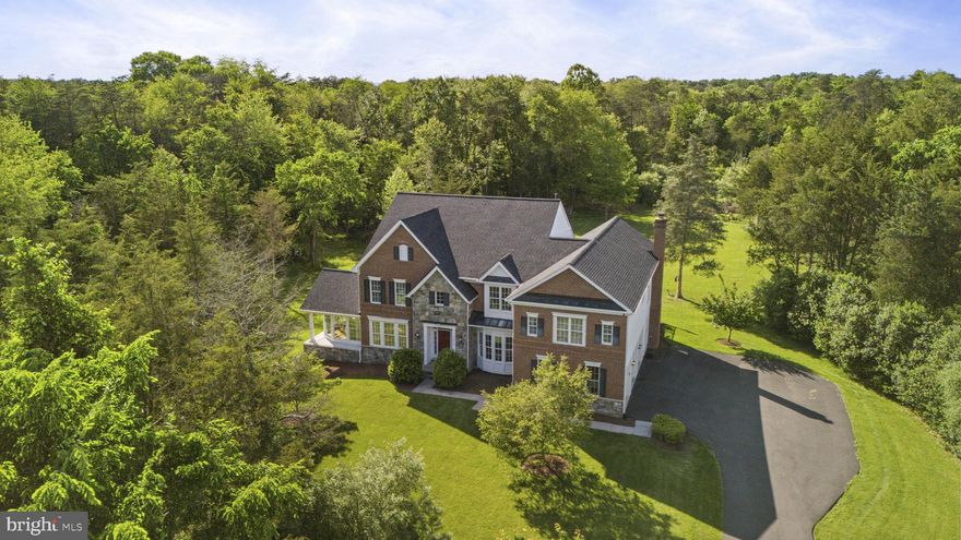 Custom brick and stone estate home located in one of the most beautiful, sought after areas of Fairfax County!  This 5 acre estate offers unparalleled privacy and luxury, and features 4 finished levels, over 7500 finished square feet, and upgrades and updates throughout!  The main level features a grand 2 story foyer w/ a curved staircase and iron balusters, gorgeous hardwood flooring, a formal living room and side solarium that share a 2 sided gas fireplace, a large formal dining room that can easily accommodate a party of 12 or more, a chef inspired gourmet kitchen with massive island, granite counters, Stainless steel GE Monogram appliances and walk in pantry.  The kitchen opens to a 2 story family room w/ floor to ceiling stone fireplace, wall of windows, and 2nd staircase that leads upstairs.  A second large sunroom off the rear of the kitchen leads to a private deck that overlooks your private oasis.  The bedroom level features a stunning owners suite complete w/ sitting room, luxury bath w/ jetted tub, dual vanities, separate shower, and 2 walk in closets w/ custom shelves.  There are 3 additional bedrooms, all with walk-in closets and private en suite bathrooms.  The finished attic level is a teenager's dream (or perfect au pair suite) and features a bedroom, en suite full bath, and living area w/ skylights!  The finished walk up basement is wide open for possibilities and features a huge recreation room, full bathroom, 2 unfinished storage areas, and a 2 tiered theater room awaiting your custom touches.  The rear yard has been cleared and provides a flat green canvas for a future pool, sport courts, fire pit and more.  Recent high quality updates include:  Roof (2022), Driveway (2021), HVAC (2018), Sump pump (2024).  PLAT in documents section.  Schedule a showing today and make this incredible property your forever home!