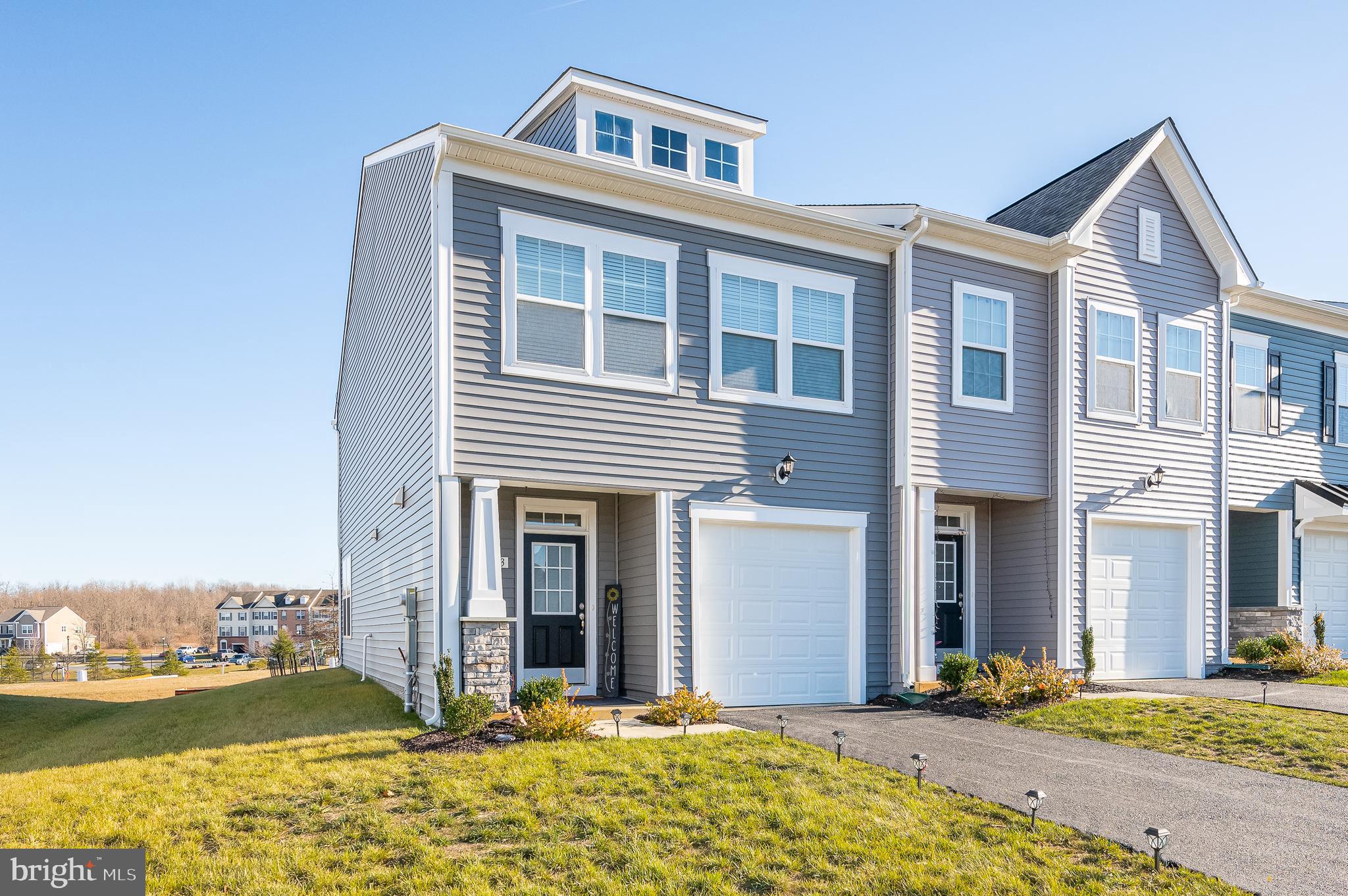 Welcome to your next home! Discover this 2024 build townhome, nestled in Berkeley County’s premier planned community of Martinsburg Station. This vibrant neighborhood offers an inviting lifestyle with its stunning clubhouse, swimming pool, serene walking trails, lush landscaping, and mountain views.
Step into the welcoming, thoughtfully designed two-level townhome that combines modern comfort with charm. Featuring a covered porch, a convenient 1-car garage, and 3 bedrooms with 2.5 bathrooms, this home is perfectly laid out.
As you enter, you're greeted by an open-concept main level boasting 9-ft ceilings and a stylish foyer with a tray ceiling. The layout includes a powder room, a coat closet, and easy access to the garage. The heart of the home is the spacious kitchen, equipped with sleek stainless steel appliances, upgraded white cabinets, quartz countertops, and a large island for extra prep space.
The family room is bathed in natural light, with additional side widows that seamlessly connect to the backyard through a stunning glass door that opens to a 16'x8' patio—ideal for enjoying outdoor gatherings or quiet moments.
Upstairs, the primary suite is a tranquil retreat featuring a tiled shower with a built-in seat and a linen closet for added convenience. This level also includes two additional bedrooms, a well-appointed hall bath with a shower/tub combo, a linen closet, and an upstairs laundry area for ultimate ease.
Make this your new home and enjoy all the community's outstanding amenities and scenic surroundings. This is where comfort meets lifestyle—schedule your visit today!