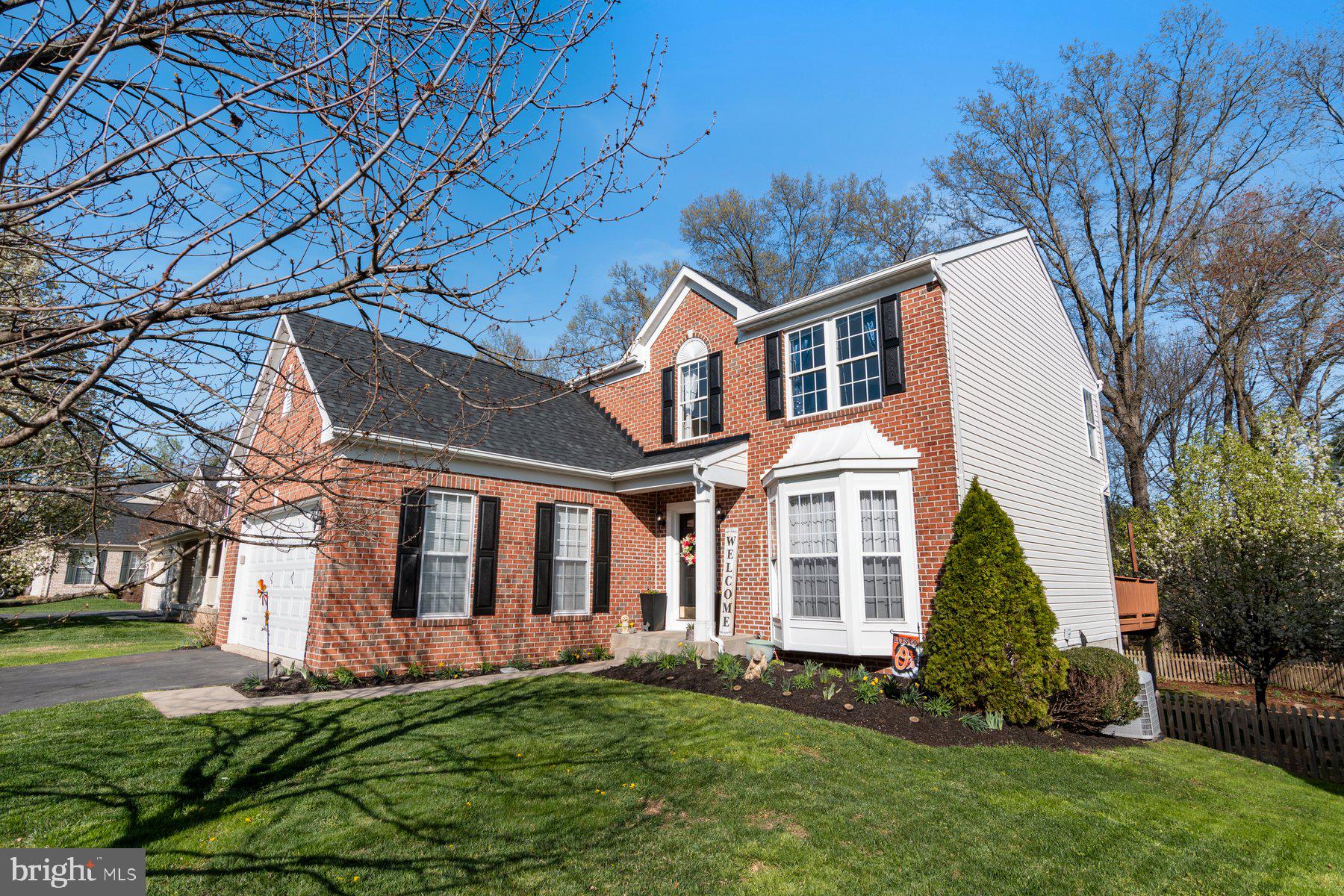 Beautiful 4BR 2.5 BA Brick Front Colonial with two-car attached garage on a premium lot backing to wooded preservation area! Updates include fresh paint throughout, a gourmet kitchen with granite counters, new backsplash, stainless appliances and ceramic tile flooring. Brand new luxury vinyl plank flooring in upstairs hallway, family room, living and dining rooms! Brightly lit Sun Room opening to the beautiful deck and fenced yard with lovely landscaping! Lovely owner's suite with en-suite remodeled bath with soaking tub and brand new frameless shower and fixtures along with a spacious walk-in closet and double vanity with new mirrors and lighting! Finished basement (presently used as a 5th bedroom) with brand new luxury vinyl plank flooring and fresh paint. So much more than you could dream of at this price! Sellers love the community and the fact they are at the end of community on a cul-de-sac. Close to walking trails and the neighborhood has safety built-in with tag monitors at the entry of neighborhood for the cars coming in and out. The walkout basement is just another amenity. Architectural Shingle roof in 2022 and all mechanicals are newer close to 2019 when current seller purchased. AGENTS: PLEASE ACCESS REAR YARD FROM LOWER LEVEL EXIT. SELLER JUST SEEDED GRASS INSIDE THE OUTSIDE YARD GATES.