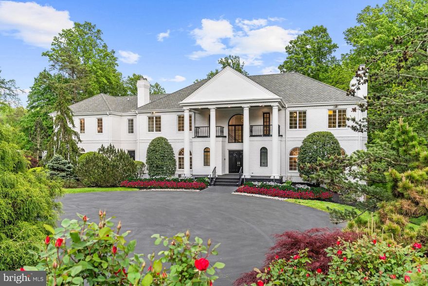 Prominently perched on a gentle knoll along the most sought-after stretch of legendary Bentcross Drive in the heart of Falconhurst, this stately Glen Mitchell colonial has gone through the magical touch of Kent Construction & Development. From its gated motor court to its sturdy brick exterior and oversized pediment, this is every bit a classic Potomac estate home as it is a modern design marvel inside. Grand double doors part ways, revealing a palatial foyer clad in imported Spanish marble. A stunning bifurcated staircase presents itself ahead, while mirrored balconies overhead showcase the double-height ceilings. A traditional center hall floor plan means embassy-sized formal living and dining rooms reflect one another on either side of the entry hall, each boasting intricate moldings, Palladian windows, and wood burning fireplaces with marble mantels. Widened entryways create effortless flow throughout the nearly 10,000 square feet of finished space, such as the one between the formal living room and the paneled gentleman's study, which also conceals a pair of pocket doors for extra privacy. Hints at the renovations painstaking attention to detail are evident, such as new doors, hardware, and immaculate oak floors stained with a walnut finish. Open to an ethereal sunroom, the gourmet kitchen is a chef's dream with its thick edge countertops, 13-foot island, and marble tile work. Top shelf appliances from Wolf, Viking, Bosch, and SubZero are embedded within luxurious cabinetry with European hinges. An attached pantry/mudroom area affords access to the heated three car garage. Upstairs, the primary bedroom suite boasts a separate sitting area with marble fireplace and occupies an entire wing of the home. Double walk-in closets with new custom shelving and a brand new spa-inspired bath featuring the rare Bianco Puro marble, twin vanities, jetted tub, walk-in shower, and cedar sauna creates an oasis-like atmosphere. The three remaining upper level bedrooms could all serve as primary suites themselves; one has a separate sitting area with wet bar, large walk-in closet, and attached marble bath, while another boasts two walk-in closets with washer and dryer as well as a sumptuous ensuite bath with separate soaking tub. An upper level recreation room has its own bar area with wine fridge and is ideal for a play area or yoga studio. The lower level, sitting almost entirely above-grade, is flooded with natural light and is an entertainer's dream. The stylish wet bar's navy blue cabinetry and penny tile backsplash juxtaposes its marble floor and sits in the center of a large, open recreation area. Likewise, a full kitchenette boasts the same backsplash and a SubZero refrigerator. Two large bedrooms, one of which makes the perfect fitness center, both have their own marble baths and access to the unique screened-in porch. Kent Construction and Development's touch goes beyond skin deep: WiFi enabled systems monitor the new four zone HVAC and garage doors, while video surveillance at the entry gate augments this sense of security. Surge protectors built into the electrical panels, a whole house central vacuum system, and all double pane energy efficient Anderson windows and doors throughout combine to create a fortress. Out back, the two acre lot is fully fenced and centrally irrigated. A Trex deck steps down to a flagstone patio surrounding the spectacular new 40-foot lap pool complete with a biologically friendly ozone system and diving board. A Sonos surround sound system facilitates outdoor entertaining. Uncompromising in its scale, finishes, and amenities, 9925 Bentcross Drive is situated in the heart of Potomac close to major airports, luxury retail, fine dining, the nation's finest public and private schools, as well as everything the city has to offer. It represents the rare estate which has it all to satisfy the most discerning buyer.