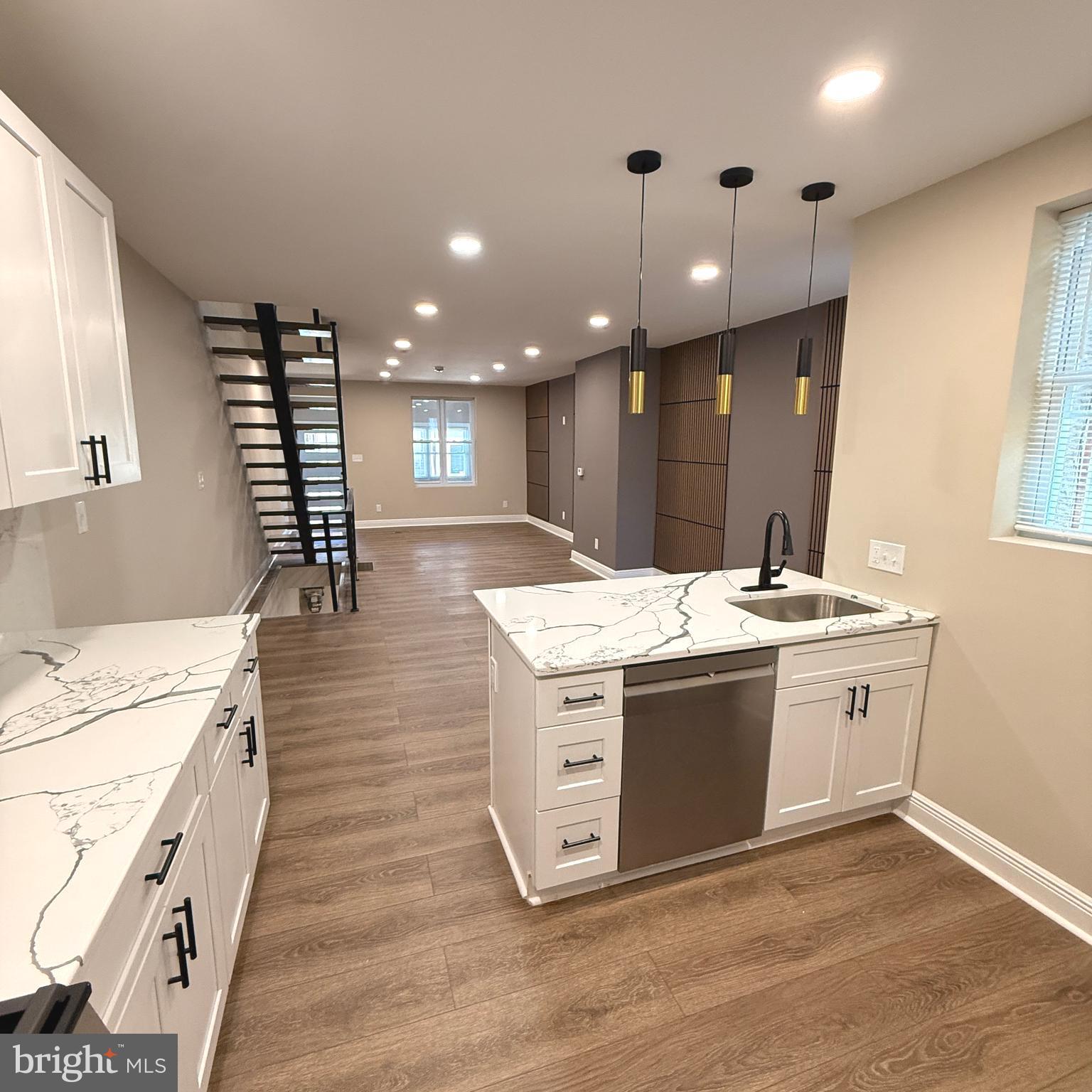 This is a rare opportunity to own a uniquely updated and beautiful home with modern finishes. Enjoy an open-concept living room featuring LED lights throughout, floating stairs, and wood wall panels that add warmth to the space. The completely renovated kitchen includes an island breakfast bar, pendant lighting, soft-close white cabinets, a microwave, a gas stove/range, a dishwasher, and a refrigerator with a water and ice dispenser.
Upstairs, you will find three well-sized bedrooms and one full bathroom. Good size finished basement includes an additional full bathroom, additional space, a separate laundry room, and easy access to the backyard, which features a porch perfect for outdoor gatherings. All bathrooms come equipped with LED mirrors. The enclosed front porch has a closet and wood wall panels.
This property is conveniently located just minutes from the airport, Center City, Cobbs Creek Park, and is easily accessible to all major roadways. Schedule your showing today and don't forget to ask your lender or agent if you qualify for the grant!