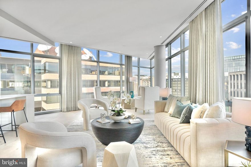 Set within one of the West End’s most distinguished addresses, Residence 7D at 22West occupies the building’s premier D-line - made even more singular by its true dining room and wraparound floor-to-ceiling glass. Commanding views and exceptional natural light animate more than 2,300 square feet of true one-level living, an increasingly rare offering of this scale framed by 9'+ ceilings and dramatic, open entertaining volumes.

Tastefully enhanced by the current owner, this residence is a turnkey offering  and impeccably finished with hardwood flooring, bespoke wall coverings, and automated window treatments offering both light-filtering and full blackout functionality. The kitchen balances design pedigree with performance, featuring Poggenpohl cabinetry, upgraded stone surfaces, and a premium Sub-Zero + JennAir appliance suite clean-lined, composed, and effortless in daily use.

A proper dining room rather than a combined living/dining arrangement creates a true hosting moment and is further elevated by a custom built-in buffet with integrated beverage refrigerator and generous storage. A separate laundry room adds a level of practicality rarely found in condominium living.

Three private bedroom suites each enjoy an en-suite bath finished in timeless natural stone and marble-forward selections, while two HVAC zones provide comfort with precision. Ideally positioned moments to multiple Metro options, Georgetown, Dupont Circle, and the downtown business district, with the ease of a professionally managed yet discreet full-service lifestyle.
Two secure garage parking spaces (#3040 and #3041) and a private storage unit (#3015) are included with the residence.