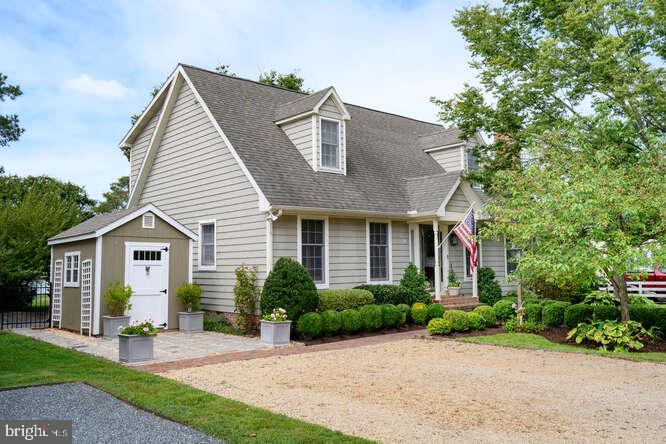This charming cape cod is located in Oxford on Town Creek just outside the Historic District on a quiet dead end street. Downstairs is a home office (with full bath, could also be used as a primary), a built-in bar, cozy den with gas fireplace, bright sunroom and fabulous screened porch. Upstairs, freshly carpeted and painted, are four bedrooms and three full baths. The awning-covered deck just off the Primary gives the feeling of a tree house with expansive Creek views. In the backyard sits a waterside cottage, “The Boathouse,” with amazing breezes all summer and in the winter it’s a prime viewing spot for the spectacular Oxford Christmas Dock tree display. Got boats? The dock has 4 slips, one currently occupied by a floating dock (conveys). The fenced yard is perfect for your furry friends. The crawl space was recently encapsulated and the attic newly re-insulated (2025). This wonderful house has it all and is as charming as it gets.