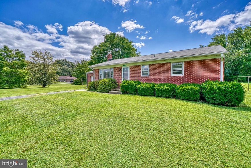 Great opportunity! Bright, brick rancher on a 4.2 acre lot and No HOA. Living room with picture window, dining area, country kitchen, hardwood floors, three bedrooms and full unfinished basement along with one car attached garage.   Property needs updating but house and expansive flat yard have endless potential. This is a trustee's sale and is sold AS -IS.