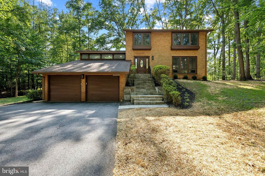 With almost $300k in upscale, thoughtful renovations, this masterpiece is not to be missed!  Welcome to this newly renovated masterpiece in the coveted Spring Hill/Cooper/Langley school pyramid.     Wind down the freshly paved driveway to the private 1/2 lot.  Enter into the main living area to soaring ceilings, hard wood floors, and light filled rooms.  A brand new open concept kitchen with stainless appliances and quartz countertops opens to the two story great room with marble fireplace.  This floor additionally has living room, dining room- with custom millwork, and office spaces, all with new recessed lighting. The half bath has custom tile work, and the back opens up to a wooded lot with a slate patio across the length of the home.  Perfect for evenings with friends.  Upstairs, find 4 spacious bedrooms and 2 full baths, including the Primary Suite with luxury bathroom with custom shower and dual sinks. There is an upscale washer/dryer combo on this level.  Downstairs, you'll find a large rec room, another full bath, and an additional bedroom. Additionally, there is a bonus room- perfect for a gym or hobby area, and another laundry room with traditional washer/dryer.  The oversized 2 car garage was finished out with walls and painted floor and EV charger. Every detail of the interior and exterior has been beautifully updated, with lush landscaping and gorgeous finishes. Minutes to Tyson's Corner, and walkable to WolfTrap through the many trails throughout the neighborhood.