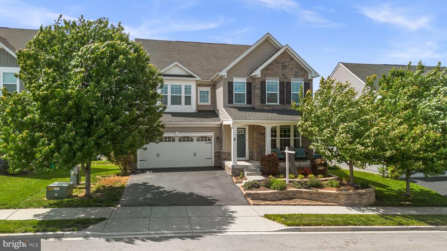 Welcome to this stunning residence, where over 5,500 square feet of thoughtfully designed living space meets the demands of everyday ease and luxury. Start your mornings on the charming front porch, the perfect place to take in the sunrise. As you step inside, you are greeted by the warmth of gleaming hardwood floors that flow seamlessly throughout the entire main level, unifying the open-concept design.

The main level is designed for both everyday living and effortless entertaining. The kitchen is beautifully appointed with bright white cabinetry and a large statement island that invites everything from quick breakfasts to gathering with guests. A built-in work station with ample storage adds convenience without sacrificing style. Open to the kitchen, the family room is anchored by an impressive stone fireplace with hearth that stretches from floor to ceiling, creating a warm and dramatic centerpiece. Also on the main level, you’ll find a walk-in pantry and large mudroom with custom cabientry, a private home office with French doors, and a spacious dining room ready to host everything from intimate dinners to larger occasions.

The upper levels are designed for rest and flexibility. On the second level, a spacious loft provides the perfect spot for a casual hangout area or playroom alongside an impressive owner’s suite designed as a true escape. The primary bedroom includes a separate sitting area, two walk-in closets with custom organization systems, and a beautifully finished bath with double sinks, a soaking tub, and a separate walk-in shower. This floor also includes three additional generously sized bedrooms, one with its own private bath, along with a laundry room and another full hall bathroom. Upstairs on the third bonus level, you’ll find a fifth bedroom, an additional full bath, and an expansive recreation area that can easily adapt to a variety of needs.

The lower level is a true extension of the home’s livability, featuring a fully finished recreation area with walk-out access to the backyard and abundant storage. Outdoors, a low-maintenance composite deck off the kitchen allows for taking in beautiful mountain views and serene sunsets.

Life here extends far beyond the home itself. Middletown is beloved for its small-town atmosphere, community events, seasonal celebrations, and everyday charm. Set in one of Middletown’s premier communities and just a short walk to Middletown schools, the public library, retail, and restaurants, this location puts everyday convenience and community connection right at your fingertips.