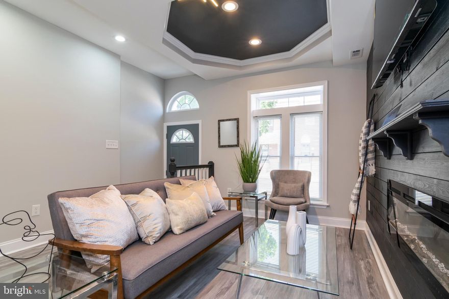 Welcome to 1907 E Lafayette Ave, a meticulously updated two-story townhouse that blends modern sophistication with timeless charm. Step inside and admire the luxury vinyl flooring that graces the main level with a full bedroom  and lower level, offering durability, privacy and contemporary living quarters. The coffered ceilings add architectural interest and a touch of refinement, enhancing the spacious, airy feel of the living area, and keeping the original charm of a Baltimore marble step row home. This home is perfectly positioned near Johns Hopkins Hospital, Clifton Park Golf Course, and minutes from Downtown Baltimore, providing easy access to shopping, dining, and entertainment. Don't miss your chance to own this beautiful fully remodeled, townhome in a vibrant Baltimore neighborhood! Tons of grant programs and down payment assistance available in this area like Live Near Your Work, Buy Back the Block, and various homeownership incentives and assistance programs. Buyer to verify eligibility....We want you in this home!!!