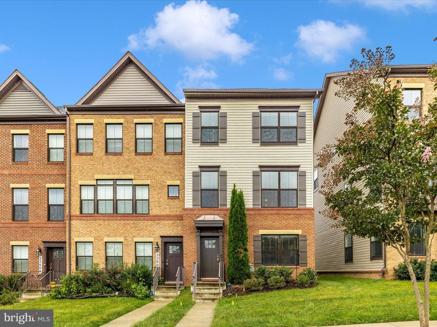 A special find among the contemporary construction of the Clarksburg Square development, this 3-bedroom 2 full, 2 half bath townhome awaits its new owners. Tucked away on a pleasant street framed by sidewalks and greenery, the home is only a short drive to the shopping and dining options of Clarksburg and Clarksburg Outlets. 
The low-maintenance yard is easy on the back, wallet, and schedule. Avid barbecuers will gravitate toward the meticulously maintained deck. Dependably crafted of composite materials, this appealing structure is the perfect stage for memorable culinary performances.

As you cross the threshold, nice touches within will make you feel at home right away. Wide-plank Engineered hardwoods gleam in the entryway, living areas, and kitchen, reflecting sunbeams of natural light. Your household stylist will find an expansive blank slate in the sunwashed open floor plan. The rustic character of beamed ceilings in the living room also makes for nice acoustics.
Opening seamlessly onto the dining room, living room, and deck, the gourmet kitchen is a central social hub of the home. A delicious concoction of quartz counters, complemented by a fashionable backsplash of stone, the room is in the classic island configuration, maximizing workspace and flexibility. For even extra counter space, there is a two-tier peninsula perfect for bar stools. Beneath stylish lighting, this headquarters of fine eating is a stage that makes every entrance a grand one. Premium major appliances keep the place running. The dining room is adorned with custom wainscoting.

The ensuite primary bedroom is well-designed and  tranquil. In addition to the convenience of the private bathroom (walk-in shower), you will find plenty of walk-in closet space to let your wardrobe breathe. The other 2 unique bedrooms are located down the hall with a separate full bathroom. With laundry on the bedroom level and a brand new washing machine, there is no excuse for not doing laundry! 
A driveway with ample accommodation for two vehicles leads to an attached two-car garage that is available for its original purpose, or you can get creative by treating it as additional flex space. 
Solar panels round out this perfect townhouse.