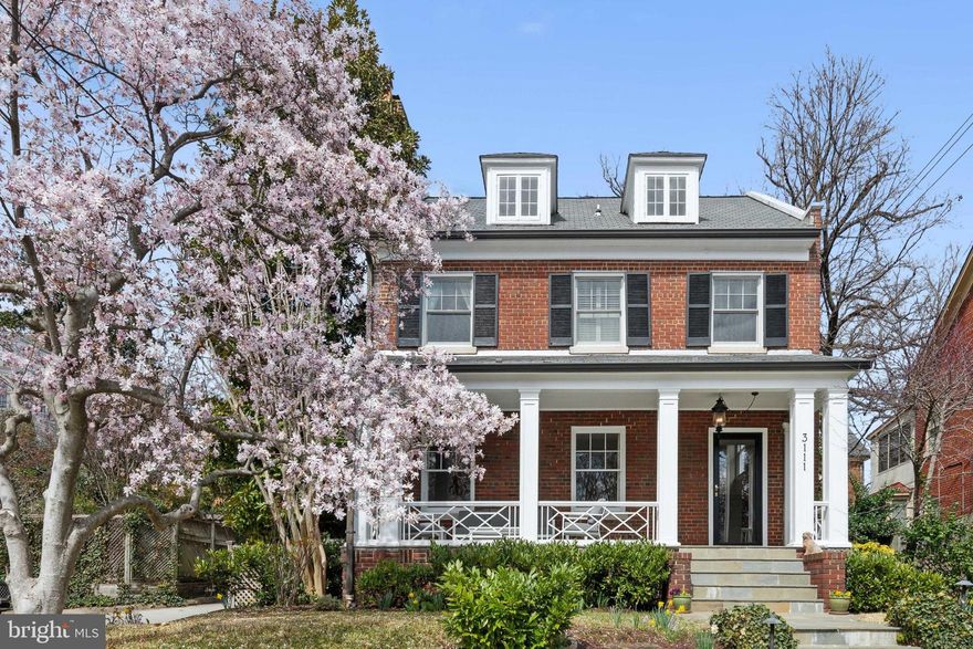 New Price!!   Nestled above Garfield Street, this delightful 1925 Colonial-style home exudes charm and warmth. The inviting front porch, complete with a distinctive railing, is the perfect spot to unwind and enjoy a peaceful afternoon or evening. Inside, you'll discover a welcoming and functional layout that effortlessly blends comfort and style.

The spacious foyer leads into the gracious living room, where a gas fireplace creates a welcoming atmosphere. To the other side of the foyer, you'll find the heart of the home – a beautifully remodeled kitchen, completed in 2023. With an eat-in island, it's an ideal space to sip your morning tea or coffee. 

Adjoining the kitchen is a large dining room, perfect for entertaining, and a separate family room bathed in natural light from surrounding windows. A sliding glass door opens onto the landscaped patio, providing a private space for entertaining or dining al fresco.

Upstairs, the spacious primary bedroom features a walk-in closet and a luxurious ensuite bathroom with dual vanities, a shower, and a tub for ultimate relaxation. Just off the primary bedroom is a bright sunroom that can easily be transformed into a sitting area, office, or study. Two additional bedrooms on this level share an updated bathroom.

The third floor, or attic level, offers even more space with a generous-sized bedroom and ensuite bathroom. Plus, there's a bonus room currently used as an office, and a large finished storage room to accommodate all your seasonal items or extra belongings.

Downstairs, the basement has everything you need for convenience and fun. There's a laundry area, a wine closet, an open playroom or exercise space, and a cozy media room – perfect for movie nights.

At the rear of the house, adjoining the back patio you'll find a two-car garage with a parking pad that can fit two additional vehicles. The garage and parking pad are accessed via a lane running along the west side of the property, offering easy and convenient parking and level entry to the rear of the house. In addition, there is exterior lighting and an irrigation system.

The location offers easy walking to schools, restaurants, and shops, and the many hiking trails in Rock Creek Park. 

This home offers the perfect blend of style, comfort, and practicality – a place you'll love coming home to!