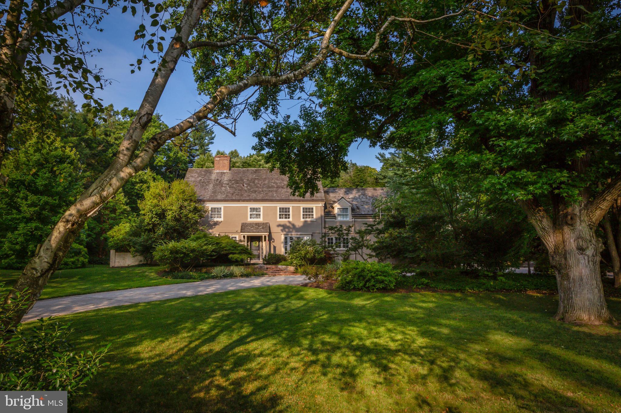 Understated elegance and luxurious amenities await you in this Haverford Colonial, located on one of the Main Line's quintessential streets. A beautifully landscaped yard and secluded pool area are among several outdoor gathering spaces on this well-maintained property. Featured in the opening scene of the award-winning movie Philadelphia, this home is within walking distance of much of the best that the Main Line has to offer. The sun-filled foyer extends a warm welcome. Stunning wood floors begin in this entryway and continue throughout the home. A cozy study features plenty of built-ins, a brick fireplace with a white wood mantel, and a large, deep-silled window with views of the expansive front yard. Plentiful windows in the traditional living room invite nature indoors, making the space feel like a sunroom. The dining room offers plenty of space for holiday meals, as well as French doors leading to a patio with lovely views of the garden. An informal living area - ideal for everyday gatherings and entertaining - provides an open-concept flow between the kitchen, breakfast room, and fireside family room. Large windows and French doors to the pool area let in lots of natural light. The thoughtfully renovated kitchen includes a vast island with bar seating for five; an apron sink under a triple window that overlooks the lovely front yard; Wolf and Sub-Zero appliances; a double oven; and even a pot-filler over the six-burner gas range. High-quality inset cabinetry offers plentiful storage. Next to a charming window seat, a built-in desk provides a home-office work space. A large mudroom with built-in storage and a powder room with a sink set within an antique, half-round table complete the main floor. Upstairs is the master suite, enhanced by a window seat and a massive walk-in closet. The luxurious master bathroom includes an oversized shower, soaking tub, and double vanity. There are three additional bedrooms on this level - each with an en suite bathroom - as well as a sunny laundry room with abundant storage. A private staircase leads to the new third floor, added in 2014. This level includes two additional bedrooms and a hall bathroom. Both bedrooms have lovely windows and provide plentiful private space for teens, guests, or quiet working from home. The lower level has a finished recreation room and plenty of space for storage. Above the detached, two-car garage is a walk-up loft well suited to be an office space, in-law apartment, or yoga or art studio. Enjoy resort-style living beside the tasteful pool. The lush perennial garden changes monthly, and mature trees give this property an arboretum feel. Stunning in the fall and spring, a 35-year-old Japanese maple is one of the biggest in the area. Enjoy nearby trails at Haverford College, as well as the Merion Cricket Club, Arnold Field, and Sharpe Park. Suburban Square and its popular farmers market is within walking distance. This home offers an easy rail commute to Center City or Manhattan.