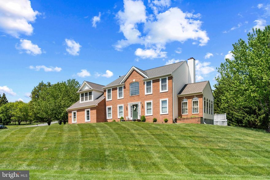 Welcome to a home that truly checks every box—space, style, and a layout designed for how you actually live. Homes with this combination of space, layout, and location don’t come around often—don’t miss it. Expansive, thoughtfully laid out, and designed for both everyday comfort and elevated entertaining, this 4-bedroom, 3.5-bath Colonial delivers the space and presence today’s buyers are looking for. The main level is anchored by a well-appointed kitchen featuring stainless steel appliances and a center island, seamlessly opening to a spacious great room—creating a natural hub for gatherings, conversation, and connection. Just beyond, formal living and dining rooms provide a refined setting for hosting, holidays, and special occasions. A standout feature of the home is the sun-drenched bonus room, where walls of natural light and serene backyard views create a space that feels both inspiring and calming—perfect for a private office, lounge, or creative retreat. Upstairs, the primary suite offers a true sense of retreat, complete with a sitting area and generous closet space, delivering both comfort and functionality. Outdoor living is just as inviting, with a large deck overlooking a flat, open backyard—ideal for entertaining, relaxing, or enjoying quiet evenings at home. A side-load garage, ample parking, and a highly convenient location near major commuter routes add to the home’s overall appeal—offering both accessibility and a sense of privacy.