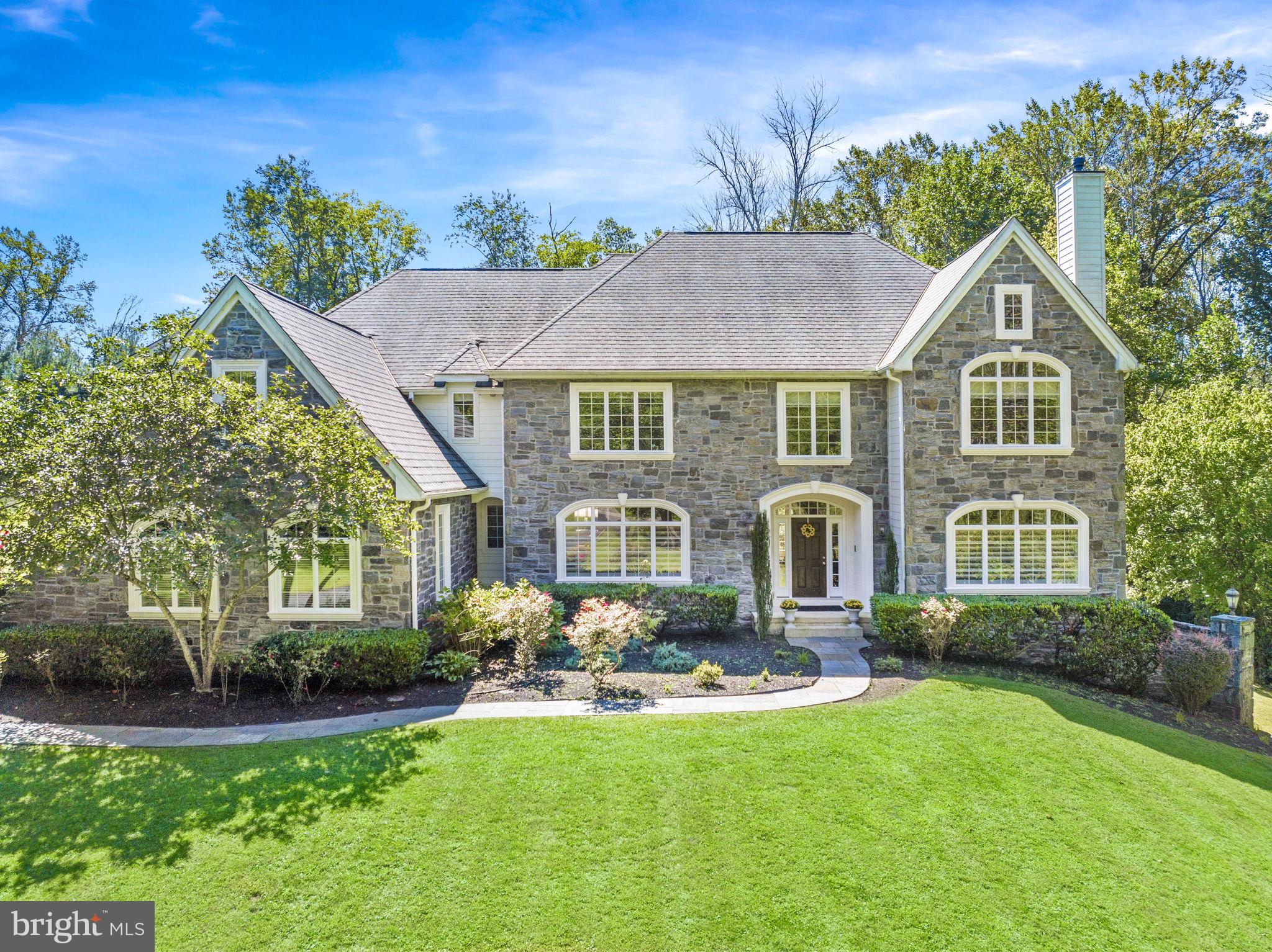 Welcome to this Megill Built exquisite Pennsylvania Farmhouse, gracefully nestled on a secluded 2+ acre lot in the heart of Chadds Ford. This remarkable home effortlessly blends timeless classic features with a modern floor plan, creating a versatile canvas suited to contemporary lifestyles. Upon arrival, you are greeted by an expansive driveway that leads to a welcoming entrance, beckoning you to explore this extraordinary 5-bedroom, 5.2-bath residence spanning over 6,000 square feet. Stepping through the custom entrance, you'll find yourself in a grand front to back 2-story foyer, where 10-foot ceilings, rich hardwood flooring, elegant light fixtures, and custom moldings adorn every corner. The first floor boasts significant upgrades that enhance the home's elegance. The spacious dining room, formal living room with a gracious fireplace, and a front-to-back entry provide captivating views of the outdoor terrace and private rear yard—perfect for hosting gatherings and entertainment. The epicurean kitchen is a chef's dream, featuring granite countertops, an oversized island, deluxe appliances, and custom cabinetry with a Sub-zero refrigerator, Sharp built in drawer microwave, Bosch dishwasher, Bosch 5 burner gas cooktop, Bosch double wall oven and Bosch warming drawer. The open kitchen flows seamlessly into the oversized family room with a vaulted ceiling and a center fireplace, all adjacent to the well-located oversized mudroom, which leads to the expansive 3-car garage. The first floor also offers a delightful corner sunroom with French doors, tile floor and a dual sided fireplace that is shared with the secluded office/study, and two powder rooms for added convenience. Ascending either of the two staircases to the second floor, you'll encounter the same commitment to high-quality finishes and meticulous attention to detail. The primary suite is a true sanctuary, featuring a cozy sitting room that leads to the primary bedroom adorned with a vaulted ceiling and a spacious walk-in closet. The spa-like primary bath boasts a vaulted ceiling, custom ceramic tilework, a soaking tub, and an oversized walk-in shower. Five generously proportioned ensuite bedrooms, three with custom ceramic tilework, and a well-appointed laundry room complete the upper floor. Additional noteworthy features of this home include a low-maintenance stone and Hardie Plank siding exterior (eliminating stucco concerns), environmentally friendly and efficient geothermal heating and cooling, central vacuum, a 3-car garage wired for an auto charging station, an unfinished basement with full bath rough-in to create your own and a breathtaking stone terrace. This magnificent property offers a serene countryside ambiance while remaining conveniently accessible to all major roadways. Furthermore, it is proudly served by the award-winning Unionville-Chadds Ford School District. Seize the opportunity to make this exceptional residence your forever home.