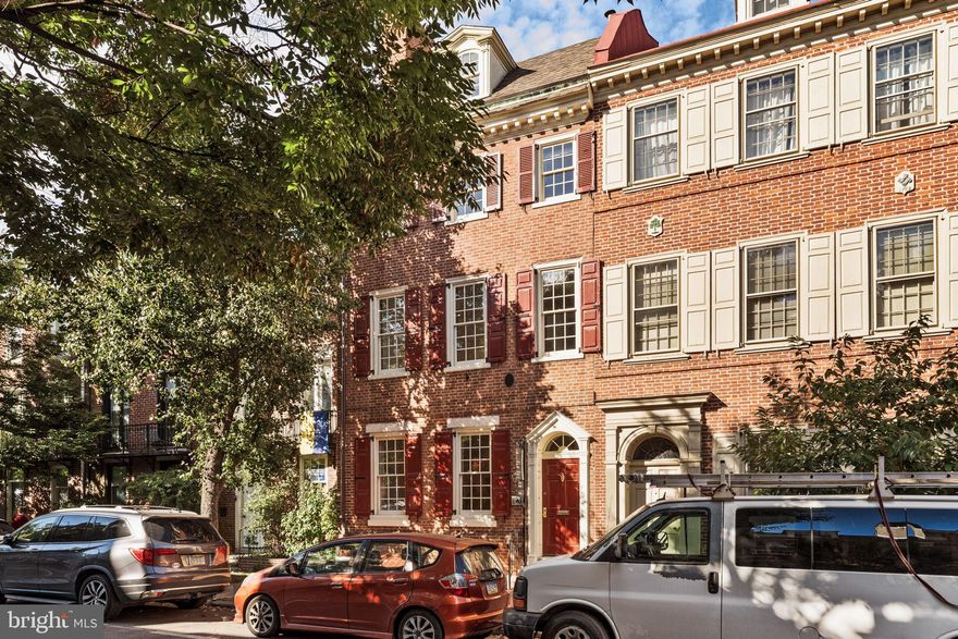 As featured in the book “Restoring a House in the City”; Historic charm meets modern luxury at 231 Spruce Street in Philadelphia’s exclusive Society Hill neighborhood. This beautifully reimagined home, with its 20' width, boasts large-paned windows that flood all four floors with southern light, illuminating its 3,400+ square feet. Featuring 4 bedrooms, 2.5 bathrooms, and a spacious bonus room with a wet bar and custom shelving, this home offers gracious living at its finest.

A harmonious blend of contemporary design and historic elements, the home underwent a thoughtful renovation a few years into the 21st century. The expansive living room retains its original pine floors (throughout) and a King of Prussia marble fireplace with a Mercer tile surround. This space flows seamlessly into an elevated dining room, which boasts a large skylight and double French doors with phantom screens that open to a meticulously maintained side garden.

The bright, spacious eat-in and renovated kitchen, features top of the line appliances, cabinetry, a panoramic paned-glass window overlooking the rear garden, is perfect for culinary enthusiasts and includes a door to the patio for outdoor grilling. Discretely located nearby are doors to a charming powder room and access to a finished basement with a tiled wine cellar, large cedar closet, and ample storage.

The second floor is home to the luxurious primary suite, which includes its own washer and dryer, two cedar-lined walk-in closets, and an elegant ensuite bath adorned with artistically set Italian Bisazza mosaic tiles, dual sinks, a double shower with dual rain shower heads, and a uniquely positioned soaking tub. A secondary bedroom is also located on this floor.

The third floor offers two additional bedrooms and a spa-like hall bathroom, while the top floor features a spacious bonus room with vaulted ceilings and exposed beams, providing a tranquil retreat.

Your 1-year prepaid parking is just down the street.

Lastly, 231 Spruce is centrally located near public transportation, Philadelphia’s historic district, and the finest restaurants and shops in the city making it the perfect blend of historic elegance and modern convenience. Your search ends here!