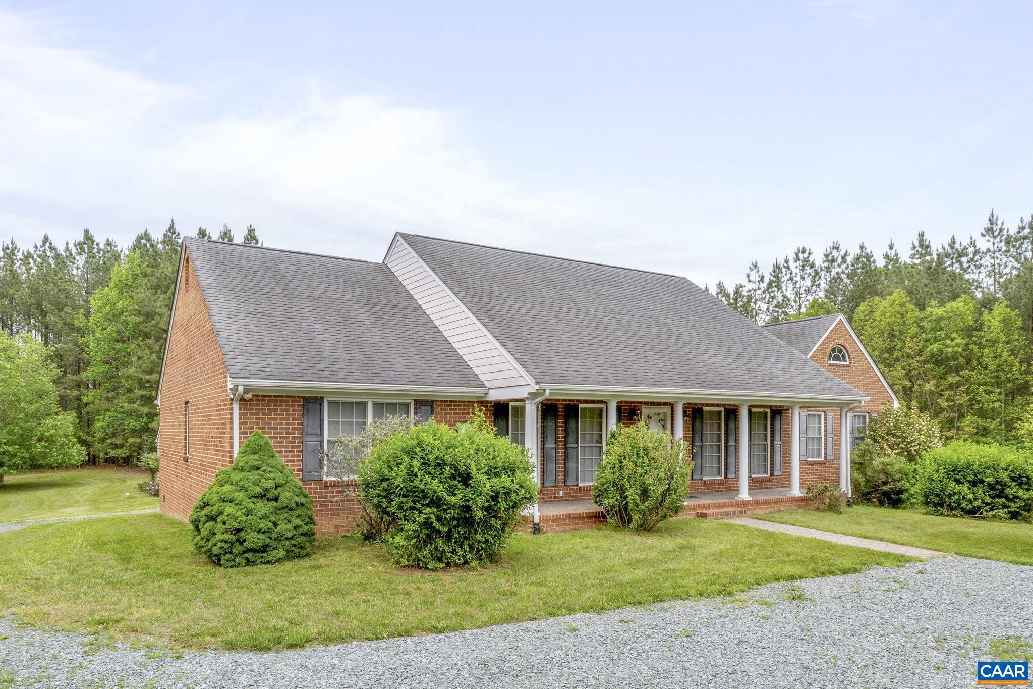 Private 20 acre retreat just 15 minutes to downtown, UVA and Charlottesville. One level low maintenance brick home with oversized 2 car garage offers a comfortable blend of traditonal charm and modern living. This beautiful spacious home boasts ample space and a layout designed for easy flow and relaxtion. Vaulted great room with gas fireplace and beautiful hardwood floors. Large four season room perfect for relaxing and enjoying nature. Popular split bedroom design offers generous primary suite with ensuite bath and walk-in closet; 2 additional large bedrooms, home office and full bath. Oversized detached 2 car garage with additional unfinished space could be workshop or finished off for additional living space.,Wood Cabinets