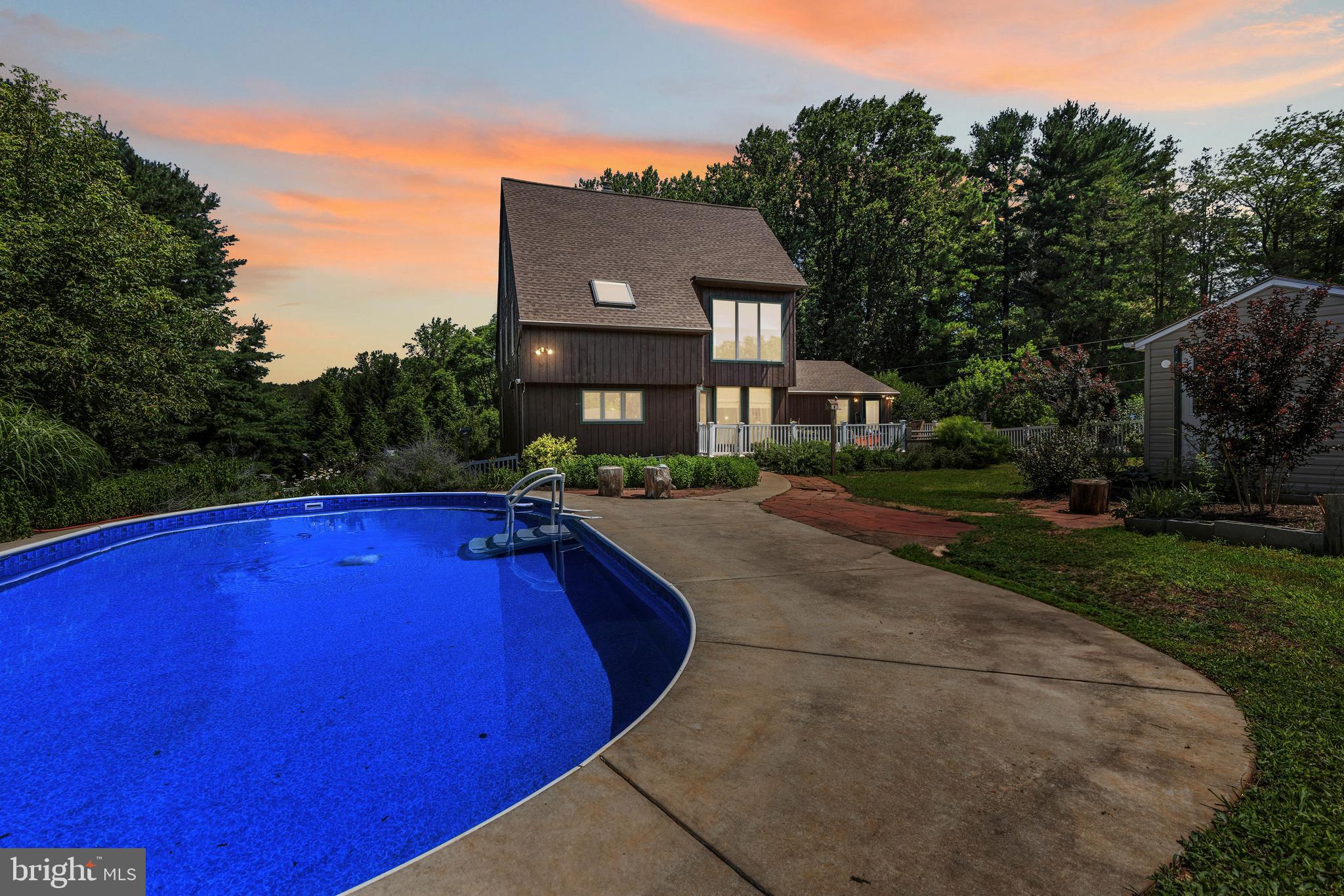 If you're looking for a unique layout and design, this one-of-a-kind cedar contemporary offers 5 bedrooms and 3.5 baths on 3.74 acres in the heart of Baldwin with plenty of privacy. Set well back from the road, this striking home features exposed beams and soaring cathedral ceilings that crown sun-filled living areas and dual lofts. Comfort meets efficiency with geothermal heating and cooling, plus a Generac generator for peace of mind. The finished walk-out lower level includes a full in-law suite with its own entrance—ideal for multigenerational living or extended stays. A wood-burning fireplace warms the main gathering space, and the attached two-car garage connects to a circular drive for added convenience. Outside, relax beside the saltwater in-ground pool, framed by mature landscaping, fruit trees (apple, peach, pear, Italian plum, sour cherry), and raspberry, blueberry, and rhubarb patches. This home offers the perfect blend of privacy, character, and smart updates—an exceptional retreat with room to grow.