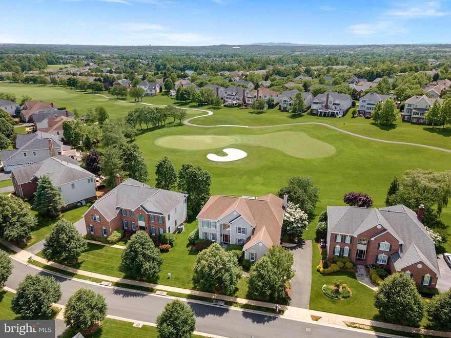 Get ready for resort style living in Belmont Country Club! This is your chance to own a truly impressive 4-bedroom, 4.5-bathroom home with unobstructed golf course views, offering the perfect blend of luxury, comfort, and everyday elegance. With over 6,000 beautifully finished square feet, this home is designed to impress, featuring resort-style amenities and stunning vistas where every day feels like a staycation.

Located in one of the most desirable, premium locations within the gates, this stunning Somerset Williamsburg model backs to the 11th green and is just blocks from the Shops at Belmont Chase, the Belmont Recreation Center, and the Country Club.

Step inside to discover the dramatic two-story family room, featuring a coffered ceiling, cozy fireplace, and a wall of windows that flood the space with natural light. French doors open to the expansive deck with a pergola and built-in hot tub—a perfect spot to unwind and take in the sweeping golf course views.

The main level also includes front and back staircases for added convenience and flow. The formal living and dining rooms provide elegant spaces for entertaining, while the private home office is complete with custom built-in bookcases, offering both style and functionality. The main level is rounded out by a spacious mudroom, laundry area, and a well-placed powder room, all with easy access to the 3-car, side-load garage.

The chef’s kitchen is a culinary dream, equipped with stainless steel appliances, including a wall oven, gas stove, Sub-Zero refrigerator , built in microwave and a dishwasher. Upgraded cabinetry, granite countertops, an oversized island, and a family planning desk make this kitchen as practical as it is stylish. Adjacent to the kitchen are the sunlit solarium and breakfast area, creating a welcoming and functional hub for everyday living and entertaining.

Upstairs, the luxurious primary suite is a true retreat, featuring a tray ceiling and serene views. The fully updated, spa-inspired bath offers a freestanding soaking tub, frameless glass shower, double quartz vanities, a separate dressing table nook, two walk-in closets, and a private water closet.

Three additional spacious bedrooms complete the upper level, including a junior suite with its own private en suite bath, and two additional bedrooms with ample closet space that share a Jack-and-Jill bathroom with a double-sink vanity. New carpet has been installed on both the main and upper levels, enhancing comfort and style.

The finished walk-up lower level expands your living space with a large recreation room, complete with a pool table that conveys. A full bathroom adds convenience, while unfinished areas provide ample storage or the potential for future customization.

For peace of mind, major systems have been updated, including a new roof and gutters (2015), HVAC systems (2017 and 2021), and stove and dishwasher (2022). Additional upgrades include LED lighting, brushed nickel hardware, fresh designer paint, and new carpet throughout, ensuring a move-in-ready experience with modern finishes.

Belmont Country Club is the ultimate resort-style community, centered around an Arnold Palmer 18-hole championship golf course. Residents enjoy a 35,000 sq ft clubhouse with elegant dining rooms and banquet facilities, along with tennis and pickleball courts, basketball and volleyball courts, a fitness center, resort-style pool, billiards room, community center, tot lots, and scenic walking trails. A vibrant social calendar ensures a lifestyle of fun and relaxation.

The HOA fee includes lawn maintenance, high-speed internet, cable TV, and trash removal.

This property is located in the highly sought-after Riverside High School pyramid, part of one of Loudoun County’s top-rated school districts.