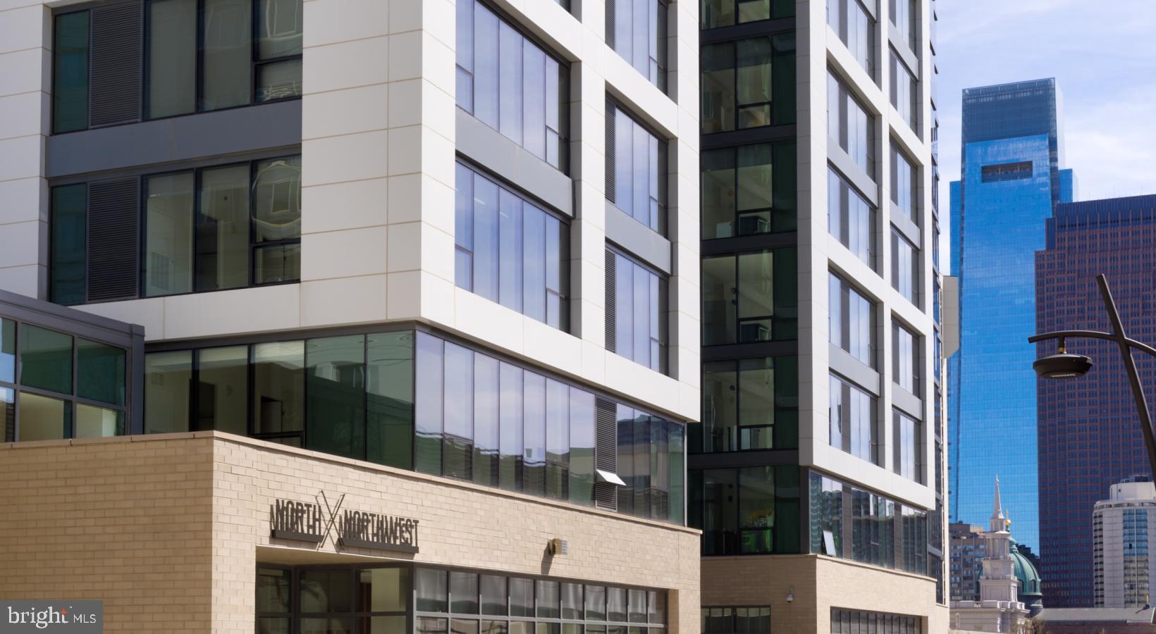 Welcome to NorthXNorthwest, a premier residential destination in Philadelphia’s iconic Art Museum neighborhood where refined living meets modern design, all set against the backdrop of some of the city’s most treasured cultural institutions. Designed for those who seek a vibrant city lifestyle without compromising comfort, elegance, or convenience, NorthXNorthwest elevates apartment living into a curated experience.
The architecture of NorthXNorthwest is a striking blend of contemporary form and urban sophistication, with expansive glass facades and sleek lines that mirror the dynamic spirit of the neighborhood. From the moment you step into the grand lobby, you’re met with a sense of calm and style—soaring ceilings, sophisticated finishes, and thoughtfully designed spaces that instantly signal this is more than just an apartment community—it’s a lifestyle.
Each apartment at NorthXNorthwest is crafted with meticulous attention to detail, offering open-concept layouts that maximize natural light and provide seamless flow from living areas to private retreats. Floor-to-ceiling windows frame sweeping views of the city skyline, Fairmount Park, and the Schuylkill River, while wide-plank flooring, quartz countertops, and premium stainless steel appliances speak to a higher standard of urban living. Spacious kitchens feature modern cabinetry and generous counterspace, perfect for quiet meals at home or entertaining guests. Bedrooms offer a serene escape, with plush carpeting and oversized closets, and spa-inspired bathrooms provide the perfect blend of luxury and function.
But what truly distinguishes NorthXNorthwest is the amenity experience, designed with an elevated urban lifestyle in mind. At the heart of the community is a resort-style rooftop terrace complete with panoramic city views, plush lounge seating, fire pits, and grilling stations—ideal for sunset cocktails or weekend gatherings. The resident lounge is styled like a boutique hotel, offering intimate seating areas, curated art, and ample space to relax, work remotely, or meet with friends. A state-of-the-art fitness center offers top-tier cardio and strength training equipment, along with dedicated spaces for yoga and functional movement training.
For residents who work from home or require flexible workspace, NorthXNorthwest offers beautifully designed co-working lounges with high-speed internet and quiet breakout zones—where productivity meets comfort. A private screening room, on-site café, and indoor-outdoor social spaces provide thoughtful extensions of your home, with design details that reflect the building’s contemporary aesthetic.
Living at NorthXNorthwest also means immersing yourself in one of Philadelphia’s most inspiring and walkable neighborhoods. Step outside and find yourself just moments from the Philadelphia Museum of Art, The Barnes Foundation, Boathouse Row, and miles of trails along the Schuylkill River. The culinary scene surrounding the building offers everything from craft coffee shops and gourmet markets to acclaimed restaurants and hidden neighborhood gems. The streets pulse with energy—lined with tree-shaded sidewalks, historic architecture, and a rich tapestry of culture and creativity.
Future residents will love not just the space they live in, but the life they live here. NorthXNorthwest offers the rare combination of upscale design, thoughtful amenities, and a location steeped in art and culture—all brought together in one of Philadelphia’s most sought-after addresses. It’s more than just an apartment—it’s a place to truly call home.
** Pricing and availability subject to change on a daily basis ** Photos are of model units ** Parking may be available for an additional fee, subject to availability **