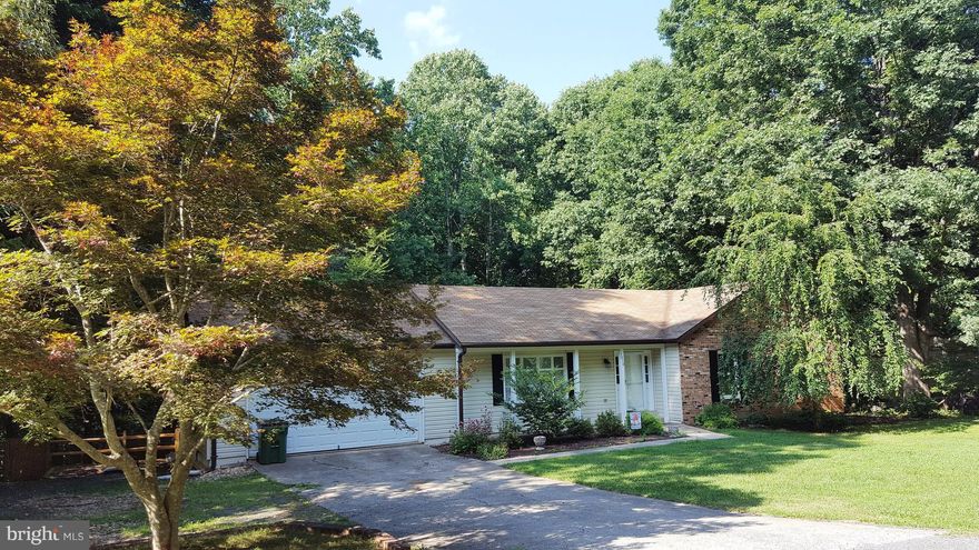 Beautifully Maintained 4 Bedroom, 3 Full Bath Rambler on an Acre+, Nestled Within a Wooded Wonderland....Country Kitchen Upgrades include Granite Counter Tops....Walk-Out from Kitchen onto Expansive Deck Ideal for Entertaining....Fantastic Master Suite with Large Walk-In Closet and 2 Additional Closets...Built-Ins throughout the Home...Full Finished Basement with Fireplace, Hardwoods & Walk-Out.