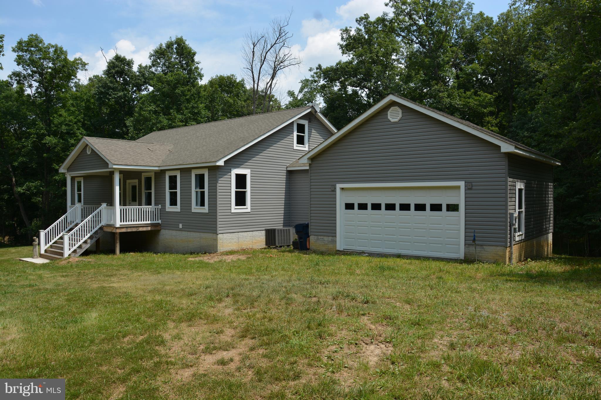 285' on the North Branch of the Cacapon. Best riverfront lot in the gated community! This rancher is a shell with exterior mostly complete. Framed interior ready to finish. Terrific floor plan. Spacious rear covered porch offers views of the river. Potential to add living space in the full basement (poured walls) or walk-up (floored) attic. Private setting. Heatpump, well & septic installed.