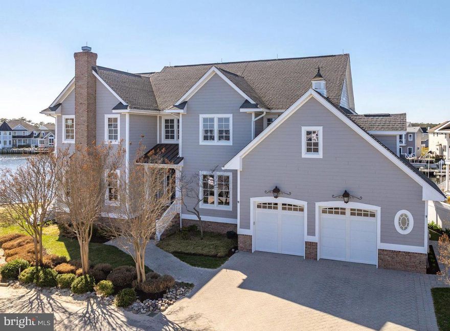Bayfront coastal style beauty! Stunning bay front views await you in this gorgeous custom designed waterfront home.  Beautifully appointed with top-of-the-line finishes, this bayfront retreat offers 4 bedrooms, 3.5 baths, 4800sqft of living space, oversized 2 car garage and everything a boater could want with ample docks and boat lifts.  Home features hardwood floors throughout, great room with pellet fireplace, family/game room, executive office with fireplace, gourmet kitchen boasting granite countertops, island, stainless steel appliances, double wall oven, large pantry and adjoining dining area overlooking the waterway.  The second level features a grand primary bedroom with two walk-in closets and a private balcony for enjoying morning coffee with a beautiful view. You will also find an ensuite guest room with private bath, 2 additional guest rooms, full bathroom and additional office space.  Don’t miss the third level completed by the current owner adding a workout/craft/hobby area as well as storage. The enjoyment is found outside with decks, docks, outside shower, balconies, covered porch and patio and taking in the awesome bay/waterfront living. Boat to offshore fishing, sunset rides, fishing, crabbing or to waterfront dining.  Only 2 miles to Fenwick and Ocean City beaches.