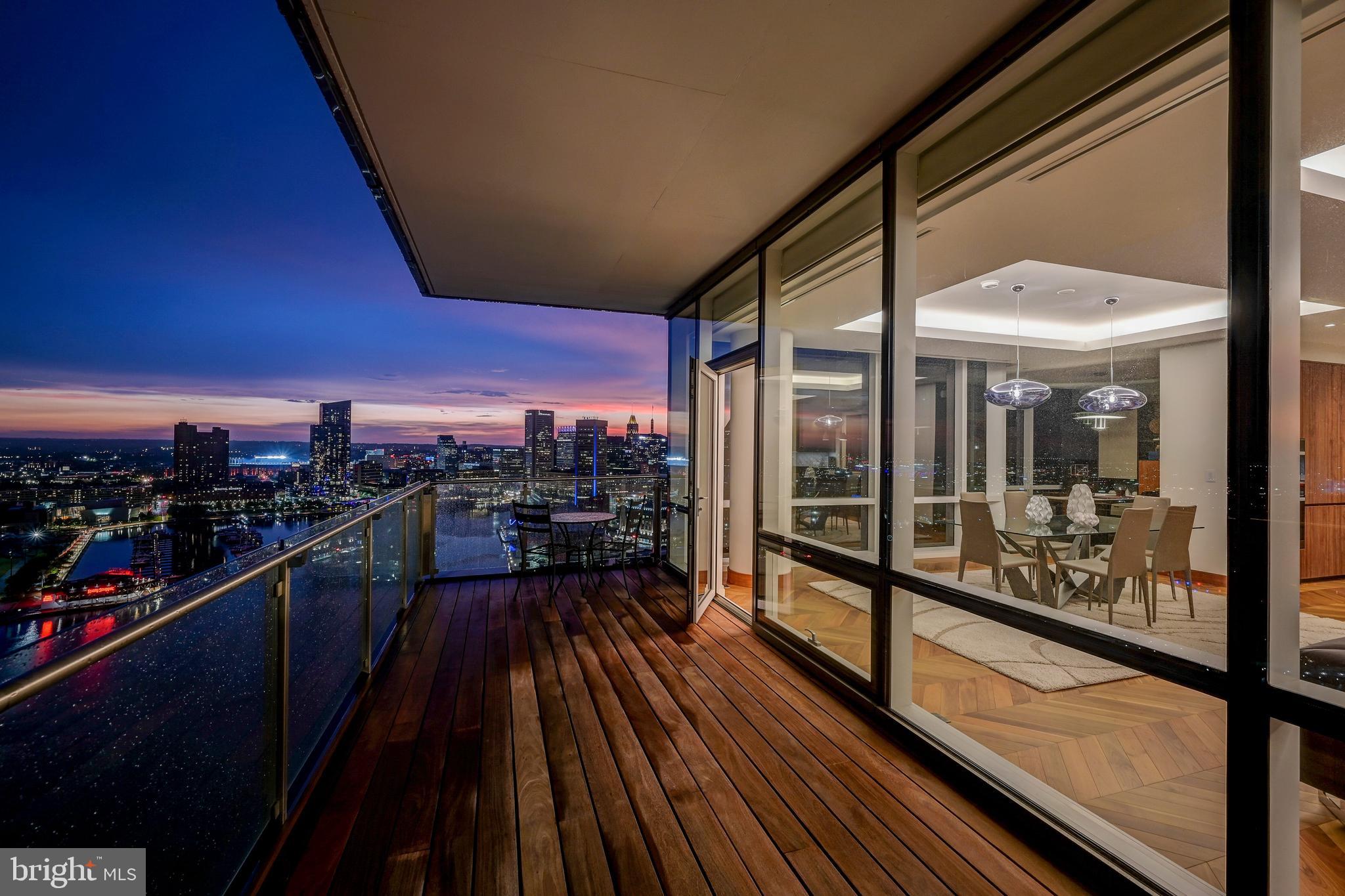Live amongst the clouds, with the best unobstructed view in Baltimore. Highlighting the epitome of luxury condo living, residence 2501 features 2,200+ square feet oozing with high end finishes and seamless open floorplan. Newly refinished herringbone hardwood floors shine upon entering into the foyer and continue throughout the home. Making the turn towards the living area, floor to ceiling windows allow abundant natural light and the most stunning view of inner and outer harbor to shine through. The Miele appliances compliment a waterfall quartz countertop, two wine refrigerators, a separate ice maker, and double oven with state of the art broiler and heating tray. Find a perfectly sized home office or formal dining area off the side of the great room, which looks over the inner harbor and Baltimore's ever changing skyline. Custom lighting throughout the home accents the vibrant wood cabinets and lively paint selection. Enter into the owners suite featuring the best views of the condo overlooking the inner harbor. The owners suite bathroom features a large rain shower with designer marble tile, a double vanity with extra counter space, and a comfortable soaking tub. The second full bathroom repeats the luxurious finishes with a rain shower as well as designer marble tiling. Bedroom number two has an equally beautiful view of downtown Baltimore's inner harbor. No expense was spared in the creation of this elegant masterpiece, from the custom window tinting treatments to the Crestron system making this residence controllable with the touch of a button. Tying all of this elegance together is the amenity floor on floor 28 of The Four Seasons Private Residences. A stunning endless pool featuring 180 degree views of Baltimore's harbor sits next to the full gym, oversized common areas ideal for entertaining, and a plethora of other amenities await. Don't miss the opportunity to own one of only 4 units with completely unobstructed views throughout the residence within the Four Seasons Private Residences Baltimore.