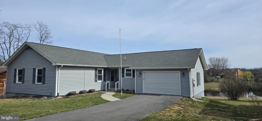 NEW ROOF 2020.   NEW WINDOWS 2023! ONE LEVEL LIVING! LAKE LIFE! It's the perfect time of year to make a move to Lake Holiday Estates, a gated community with 240 acre lake, kayaking, boating, water, skiing, clubhouse, sandy beaches, fishing, volleyball, tennis and pickleball!    
111 Masters Drive is conveniently located  close to the front gate and about a mile and a half from the clubhouse on the lake.  Enjoy one level living in this ranch style home with 3 bedrooms & 2 full baths.  The cozy family room has a wood burning fireplace to keep you toasty in the winter months!  Unfinished basement is perfect for an exercise room, game room, or storage. Large deck spans across the length of the home providing a beautiful view of the pond & the common area, peaceful settings with sunrises and sunsets and lots of nature