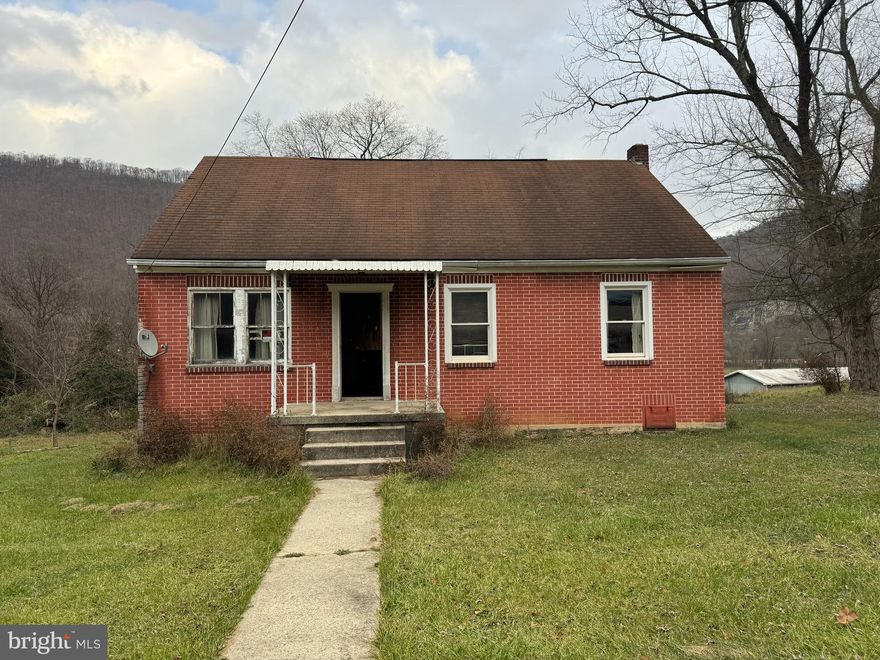 This property is ready for your TLC.  Masony Cape Cod style dwelling with full basement.  Located on a 0.4+ acre lot.  Conveniently located near the Allegany County Fairgrounds.  Two attic rooms provide plenty of bedroom space.  Full walk-out basement has potential for workshop or additional living space.