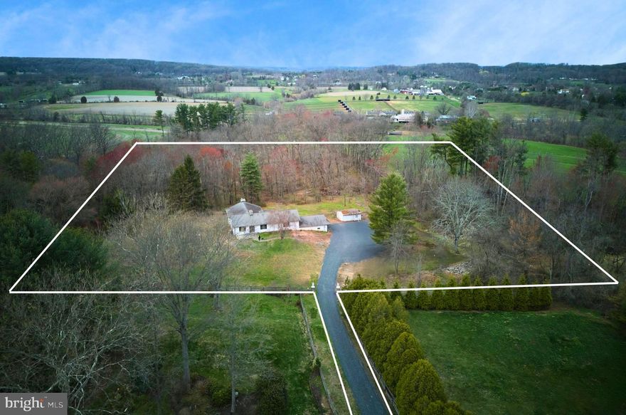 Nestled at the end of a secluded private driveway, discover four acres of raw, untapped potential, patiently waiting to be adopted by an insightful Buyer. Just like finding a lucky "golden ticket", this diamond-in-the-rough, ranch style home offers an opportunity to creatively renovate or redevelop the site. The building envelope is located in a serene woodland setting, delivering tranquility and captivating scenery from every perspective. The existing residence requires a renovation and is being offered in its current AS-IS state. Whether you choose to build new construction or renovate the home, seize the opportunity to showcase  the beautiful rear yard views with a wall of windows. The owner has recently installed a 400 foot well with a constant pressure pump, graveled the driveway and removed many dead trees. The property is listed for sale without any pre-attached building packages, allowing you the freedom to engage your own architect and builder to customize your ideal residence. (*Attached renderings are by LUCE Architects and are purely design inspiration for a proposed new home.*) Spring is the season of reinvention, rebirth and rejuvenation; the perfect time to realize the beauty of an opportunity. Avoid the remorse of missing this moment- take the leap, embrace the adventure and follow your intuition to design the life you've always imagined at 5720 Ridge Rd.