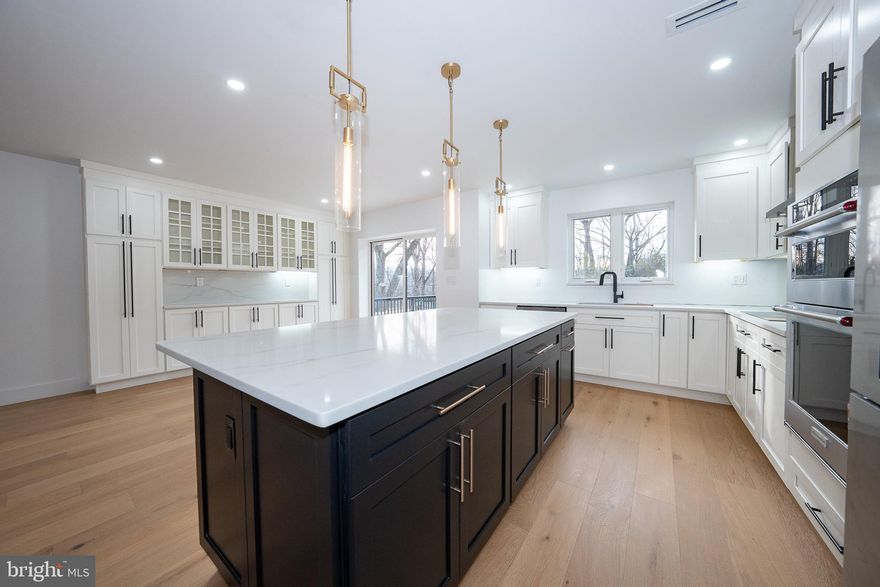 Luxury Living, Completely Reimagined — A Modern Masterpiece on a Private Cul-de-Sac  

Step into a home where every detail has been intentionally redesigned for today’s lifestyle. Fully renovated down to the studs, this 3,313 sq ft split-level foyer delivers a seamless blend of craftsmanship, modern comfort, and elevated style.

A bright, open-concept main level showcases 7" European Oak hardwood floors, an abundance of LED recessed lighting, and expansive Marvin windows and doors  that bring in exceptional natural light. The show-stopping kitchen features Century custom cabinetry, quartz countertops, a premium KitchenAid appliance suite, custom built-ins in the dining area, and an oversized island—perfect for both cooking and entertaining.

Ascend to the upper level to discover the primary suite oasis—a private retreat featuring a luxurious bath with heated floors, an oversized multi-head shower, soaking tub, dual vanity, and separate water closet. A spacious custom walk-in closet leads to an additional finished room ideal for a home office, yoga studio, or seasonal storage.

 The home also offers three well-appointed bedrooms, each with custom-fitted closets. Two bedrooms share a stylish hall bath with a bathtub, dual-sink vanity, and private water closet, while the third enjoys its own ensuite with a walk-in shower.

A half bath and custom laundry room/mudroom make daily living a breeze. The mudroom is designed with built-in cabinetry—ideal for keeping shoes, bags, sports gear, and all the kids’ essentials neatly organized. Whether you're coming in from the garage or heading out for the day, this stylish drop zone helps keep everything in its place

The lower level offers an inviting second living space with durable LVP flooring, a wood-burning fireplace, and a beautifully crafted custom bar complete with sink and additional Zephyr refrigerator—an entertainer’s dream. 

Every system in the home has been upgraded, including a brand-new 320-amp electrical service, full insulation upgrade, and dual new HVAC systems, delivering comfort and efficiency year-round.

 Exterior enhancements include new lighting and a modern garage door, and a large deck accessed from the dining area  making the home as impressive on the outside as it is within.