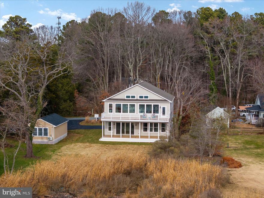 Discover the perfect blend of modern craftsmanship and coastal charm in this exceptional new construction home—already built and ready for you to move right in! Peaceful water views, open skies, and the simple pleasures of coastal living this home was designed and built by Whitehall Building & Company, known for meticulously crafted custom built residences with elevated finishes. This particular home  offers two levels of stunning waterfront living with walls of oversized windows on both levels showcase sweeping views of the creek and natural light that fills every room. Throughout the home, luxury wide-plank flooring and board-and-batten wall treatments add timeless warmth and architectural interest. On the main level, you’ll enter the home through a beautiful glass paned door and find a large family room with sliding glass doors opening to the back deck. This level also includes two bedrooms with large closet and each with its own en-suite bath, providing comfort and privacy for guests or family. The spacious open-concept reverse floorplan features soaring 16-foot vaulted ceilings on the upper level with wood beams and a cozy fireplace that sets the tone for relaxed yet refined living. The gourmet kitchen is a true showstopper, complete with a large island, stainless steel appliances, quartz countertops, and abundant cabinetry. There's a hidden, cabinet-faced door to a walk-in butler's pantry which provides exceptional functionality - generous storage space, built in shelving, a closet and countertop space. Imagine plenty of space for countertop appliance storage, beverage and food storage, as well as dishes or linen storage. The primary suite is also located on the upper floor to take advantage of the best water views and continue the home's sense of a coastal retreat. The luxurious primary bath was designed with dual vanities, a soaking tub, and a separate shower. An additional bedroom and en-suite bath are located on the upper level. Outdoor living is equally memorable, with two expansive decks which are a wonderful extension of your entertainment space on both levels. Whether privately enjoying your morning coffee or hosting friends for sunset gatherings, these outdoor spaces invite you to truly embrace the laid-back waterfront lifestyle. There is a two car garage.  Come and make this stunning waterfront retreat your new home. Enjoy the scenic shores of Parker Creek in the vibrant waterfront town of Deale, a community rich with character, multiple marinas, and a variety of great dining options. All within a convenient distance to DC or Annapolis.