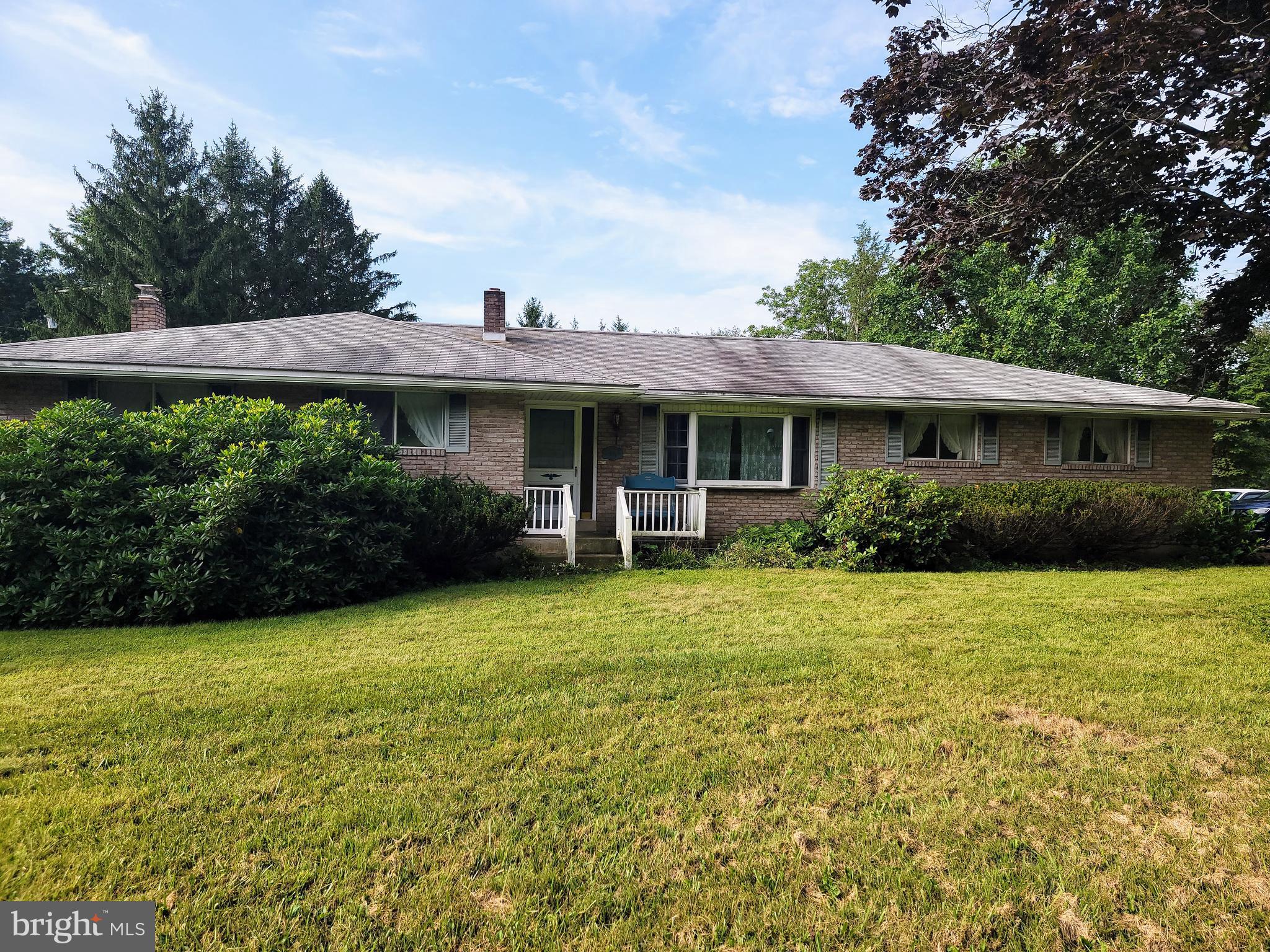 BACK ON MARKET Solid brick ranch offering room to grow and make it your own! Set on 1.5 peaceful acres in a rural setting. Enclosed porch and beautiful yard is ideal for entertaining friends and family. This home features a renovated kitchen with cherry cabinets, island and stainless steel appliances. There is a generous sized bonus space located next to the kitchen to use as a future mudroom/laundry combination, home office, game room, play room or additional family room. Move in ready condition, bring your vision and make it your own. Fully finished basement includes large family room with brick wood burning fireplace, bedroom, bathroom, laundry and utility area. The basement has a walkout to an enclosed porch. An attached one-car garage plus a large detached garage with carport that could be used for camper storage—ideal for hobbies, storage, or workshop space. A great opportunity to own a well-built home on a beautiful property! Conveniently located less than a mile to Route 61.