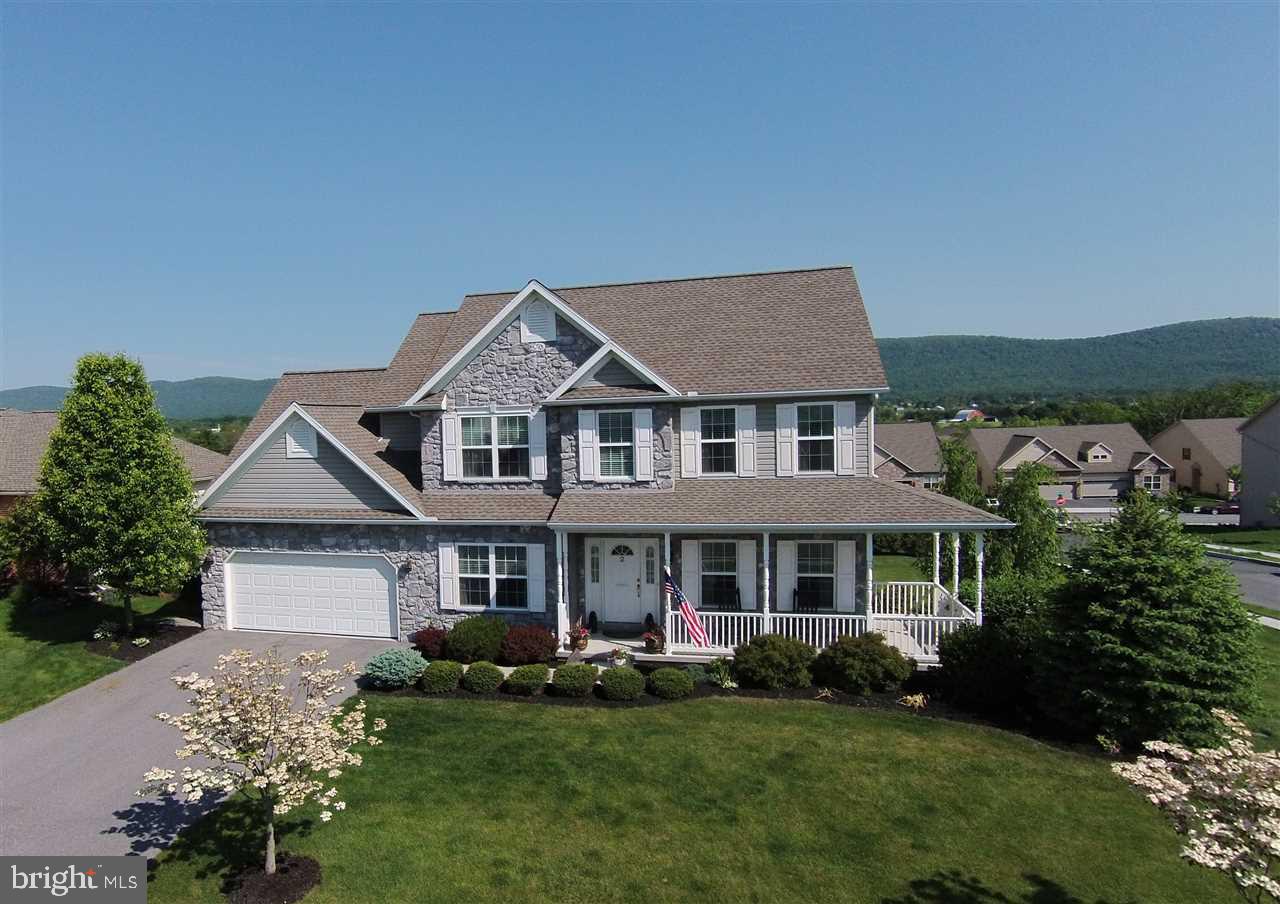 Beauty at its best! This stunning 5 bedroom, 3.5 bath traditional home in the desirable neighborhood of North Ridge, is waiting for you to be its next owner! Featuring gorgeous hardwood floors, a spacious guest suite, formal sitting room, gas fireplace and rear deck access, all on just the first floor. Upstairs you'll find 4 large bedrooms and 2 full baths. The rest of the home includes a fully finished, walkout basement with counter and storage space, a 2 car garage and breathtaking views!