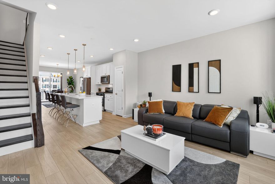 ***NOW OFFERING: $2,500 closing cost credit to Buyer on top of the $25,000+ in upgrades!!** Welcome to a nearly new, impeccably upgraded residence that delivers the sophistication of modern living with the warmth of a truly inviting home.

Less than a year old and already enhanced beyond builder standards, this exceptional three-bedroom, three-and-a-half-bath home makes an unforgettable first impression. Sunlight pours across wide-plank light Oak LVP flooring that spans every level, while dramatic Dark Oak stairs create a striking architectural statement. The heart of the home's main living space is both refined and welcoming. The open-concept main living space was designed for both refined entertaining and effortless daily living, anchored by a chef-inspired kitchen featuring striking quartz countertops, and upgraded appliance package. Sleek and modern finishes that feel both timeless and luxurious. Smart-home technology enhances everyday convenience, while custom cordless honeycomb shades with blackout overlays on every floor create a private, serene retreat day or night. The primary suite is a true retreat, featuring dual closets and a spa-inspired bathroom adorned with stunning ice-white quartz, frameless glass walk-in shower. A luxurious sanctuary to begin and end each day. A secondary bedroom enjoys the privacy and convenience of its own full ensuite bathroom. The versatile lower level adds even more value with a full bath and bedroom that includes a full wall bed — ideal for a luxe home office or private guest suite.

Step outside onto low-maintenance Trex decking, an ideal extension of your living space for effortless indoor-outdoor moments. An electric-vehicle pre-wire with Tesla charger included to reflect a home built for the future while grounded in timeless style.

Rarely does a home combine new-construction freshness, completed premium upgrades, walkable convenience, and true move-in-ready ease so seamless.