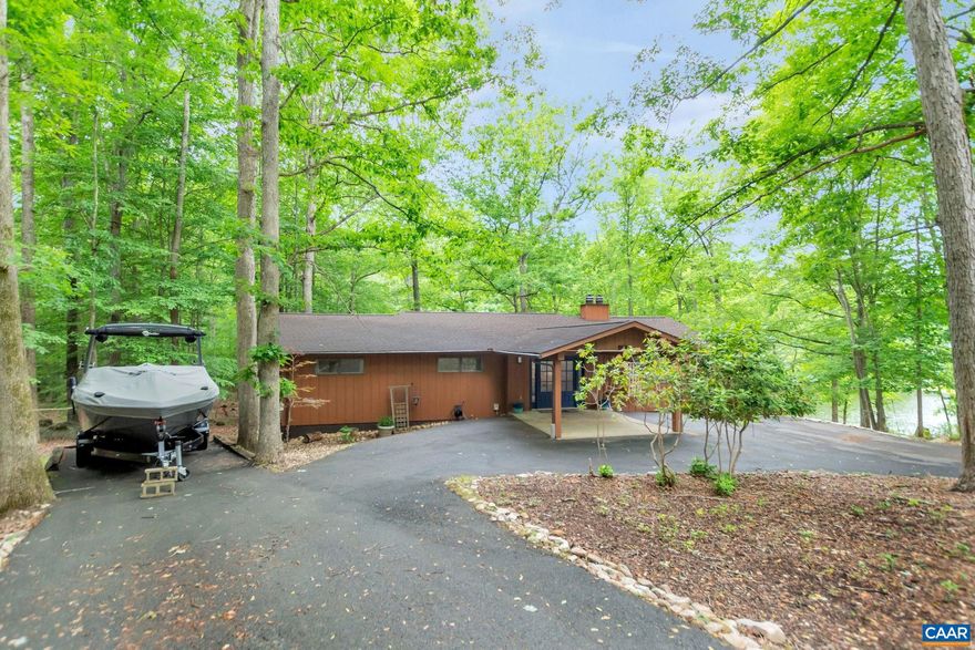 Look no further! Move in Ready & Updated WATERFRONT HOME at beautiful Lake Monticello. This immaculate home is situated at the end of a cul de sac with 155' of serene waterfrontage w/boat dock.  Great Swimming, fishing & boating. Swim to the beach. Enter from the Portico into your Double Door entrance & foyer. No steps into home. 1st level features a formal dining room w/built in shelving, living room w/wood burning fireplace, built in bookshelves & a huge vaulted Sun Room w/access to viewing deck. Open kitchen concept has breakfast bar, solid wood cabinets with glass fronts, pull out drawers & deep pan drawers. New Stainless appliances (2022), large pantry & a breakfast room.   There is a 1st floor owner's suite w/water views, attached bath, 2 large closets.  2 additional bedrooms & full guest bath on this level. Enter into the lower level to a HUGE Rec Room, home office, 2 additional bedrooms & full bath, 2 linen closets & large utility room. A concrete patio welcomes you to the back yard & gentle walk to the dock & water.  New HVAC (2022), New Roof (2021), New lighting fixtures, NEW plumbing throughout (2021),  Large circular driveway w/RV, Boat Parking. Total basement renovation 2021, New gutters & gutter guards (2020).,Fireplace in Living Room