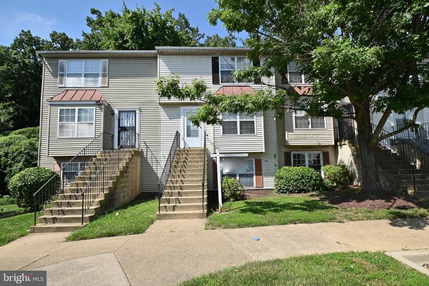 Amazing opportunity to own this freshly painted, neutral decor, two level, 3 bedroom, 1.5 bath condo in move in condition - ideal for investors or homeowners. The main level has a center galley kitchen with a separate dining and living area, and a powder room for convenience.  The upper level houses a sizeable primary bedroom, 2 additional bedrooms and a hall bath.  The spacious deck that faces a treed conservation area has space for 3 season entertainment and bbq's. There is reserved parking and ample visitor parking options.  This property is close to the beltway, Metrobus and rail, shopping, AAFB, Washington DC and more. Don’t wait.  Schedule a showing today.  “Sold As Is” but shows well.