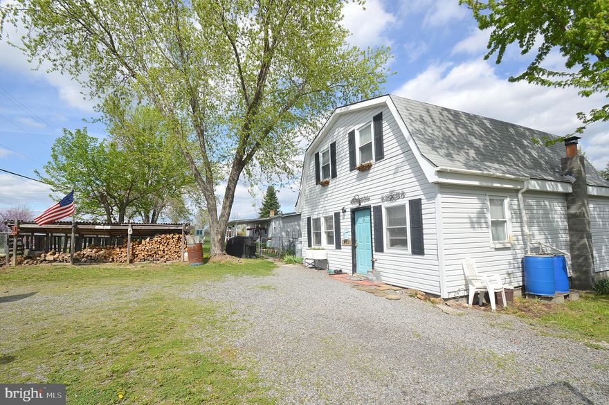 Very unique opportunity and property.  Beautiful views from the front or back of the property. Two dwellings fronting a state maintained road.  5 acres includes sheds and plenty of space for gardens, animals, and much more.  Primary dwelling features a large open living room, kitchen, and dining areas.  A wood stove, propane heater, an upstairs bedroom, and plenty of space for storage are also nice touches.  Less than 10 minutes from town, but a nice country atmosphere. Secondary home is a 2 bedroom, 2 full bath modular home.  It has a fenced yard, and a screened in back porch.  Laminate floors, a wood stove, a covered front porch, and large living room space are other  nice features.