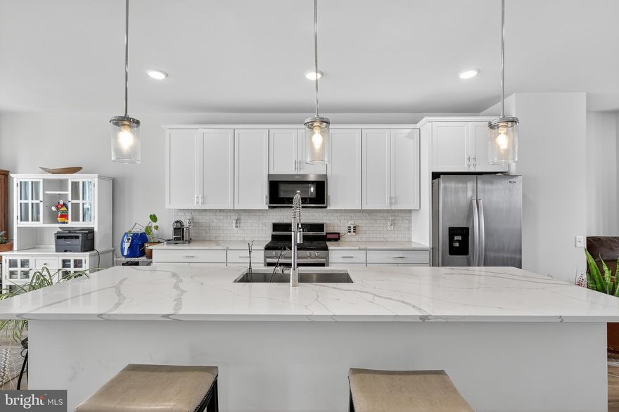 **Just steps from the Potomac Shores Golf Club clubhouse and pool and overlooking the 16th hole of the Jack Nicklaus-designed Potomac Shores Golf Course!!**  Elevated Views, Exceptional Layout, Prime Living — This Greywood townhome at Potomac Shores Town Center sits directly along two golf course fairways, offering expansive green views and instant access to the clubhouse. Inside, you'll find 3 spacious bedrooms, 2 full baths, and 3 half baths, conveniently placed throughout the home. Two full baths serve the upper level, while a half bath is thoughtfully positioned on each of the main, lower, and upper loft levels. The open-concept kitchen takes center stage on the main floor, surrounded by generous gathering areas. with an upgraded island and upgraded backsplash. Upstairs, the private rooftop terrace offers panoramic golf course views from the loft, complete with its own powder room, ideal for hosting or relaxing in elevated comfort. With parking for 4 and 3.5 finished levels, this home delivers a refined lifestyle in one of Northern Virginia’s premier waterfront communities. Located just across from the Shores Club, enjoy direct access to resort-style pools, a professional gym, the Tidewater Grill, and scenic riverfront trails. The future VRE station and Town Center will soon bring even more value and connection to the area. Don’t miss this chance to own in one of the region’s most exciting master-planned communities. Schedule your showing today and secure your place at Potomac Shores.