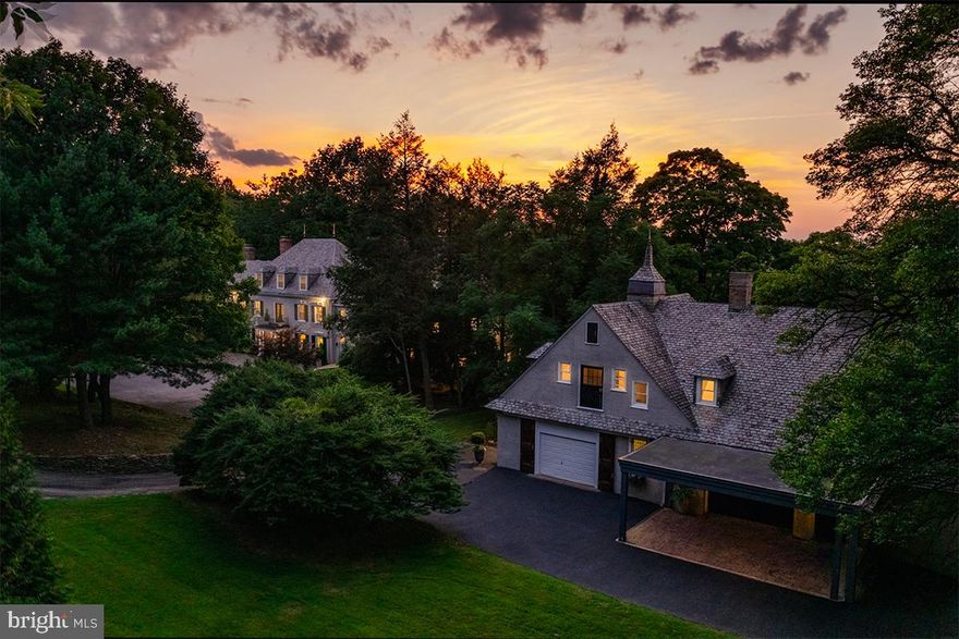 Turn the key and watch the magic unfold. 8501 Flourtown Avenue is a remarkable fusion of past and present. Originally built for a prominent railroad magnate in 1890, this magnificent estate has been transformed into a modern masterpiece. This fully restored, move-in ready residence pairs timeless architectural beauty with soaring ceilings, original millwork, and rich historic character along with every contemporary luxury. No detail has been overlooked in its high-end renovation, including cutting-edge smart home technology that is thoughtfully woven into the property, allowing you to manage key features right from your phone. This is not just a home; it’s history reimagined for 21st-century living.
Experience the perfect blend of peaceful country living and urban convenience at 8501 Flourtown Avenue, a serene retreat just a short drive or easy train ride from Center City Philadelphia. For those who travel frequently or enjoy weekend getaways, this home is strategically located to provide seamless access to New York City, Washington, D.C., and all the major airports. Surrounded by its own 3.7 acre manicured parkland setting, the residence is found at the end of a private road, behind iron gates and a long winding driveway just beyond the city limits. Every detail of the renovation reflects thoughtful craftsmanship and refined taste, from the custom chef’s kitchen outfitted with Viking and Sub-Zero appliances, quartzite counters, and a striking Calacatta marble backsplash, to the 8.5 luxurious new bathrooms featuring Toto smart toilets and frameless glass showers. The expansive primary suite is a private sanctuary, boasting dual en-suite baths with heated marble floors, a walk-in dressing room with a marble-topped island, and bespoke built-ins. Five additional bedrooms, each generously sized and thoughtfully updated, offer comfort and style for family, guests, or flexible use as home offices or creative spaces.
Entertain or unwind in spaces that surprise and delight including a hidden speakeasy tucked behind the library fireplace, a century-old wine vault and safe-room, a full gym, sauna, and a serene massage/yoga studio. Smart-home technology controls new high-efficiency HVAC systems, providing ease and comfort at your fingertips. Step outside to a newly completed 2,000+ square foot sandstone-style terrace that connects effortlessly to the home's interior, offering an ideal setting for both intimate evenings and large-scale entertaining.
The story continues in the stunning 4,000+ square foot carriage house, originally designed circa 1900 by the acclaimed architectural firm Cope and Stewardson. It features rich mahogany stables, rustic chandeliers, and a soaring party barn, bringing charm and character to match the main estate’s refinement.
This is more than a home…it’s a lifestyle. A place where sophistication meets comfort, where historic architecture meets modern luxury, and where all the hard work has been done for you. Just move in, settle down, and enjoy the best of both worlds.